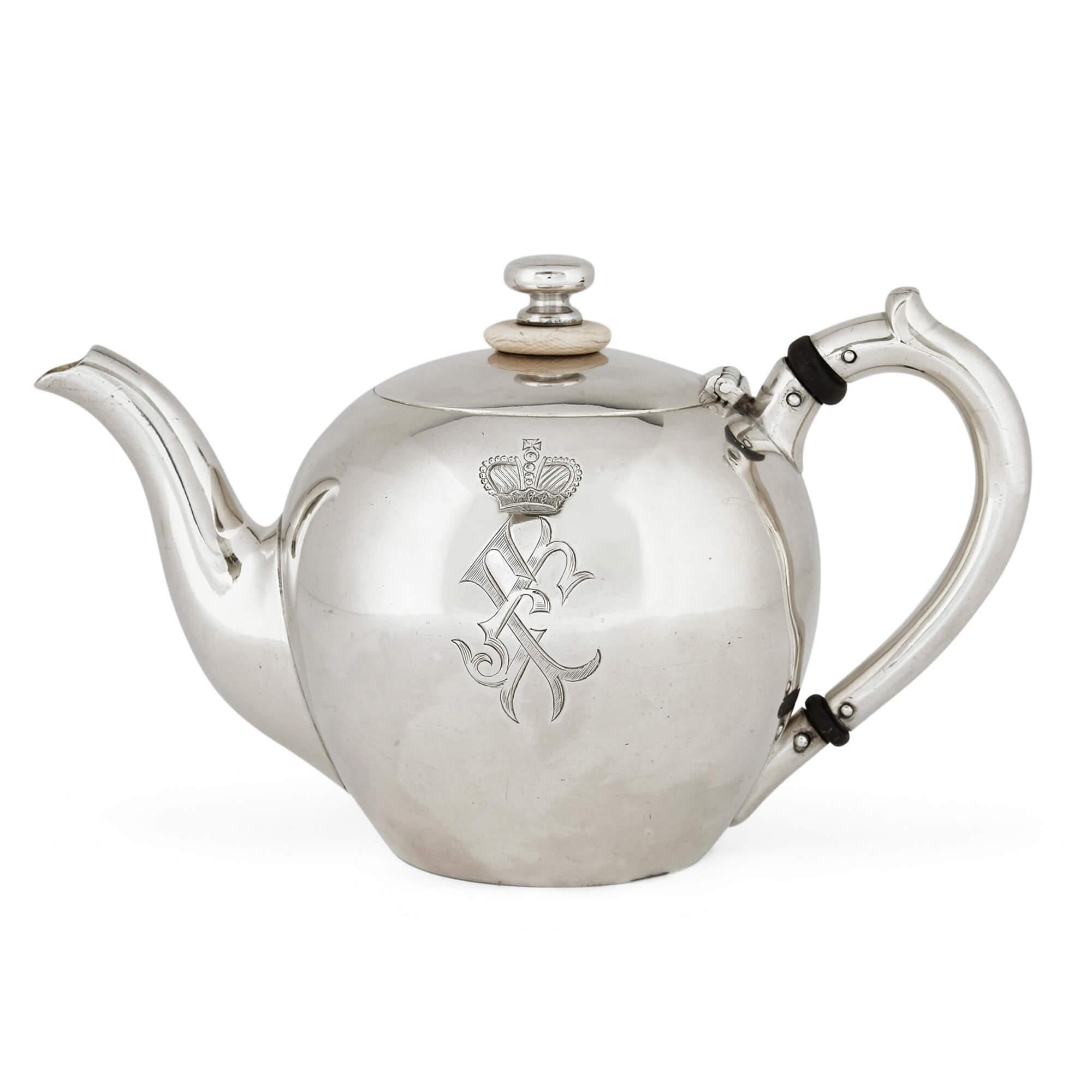 This fine and charming silver tea-set comprises a teapot, a sugar pot with a spoon and two jugs; one smaller and one larger. Each piece features an engraved crest and crown to their bodies, as well as gilt interiors and full hallmarks. Made c.1900
