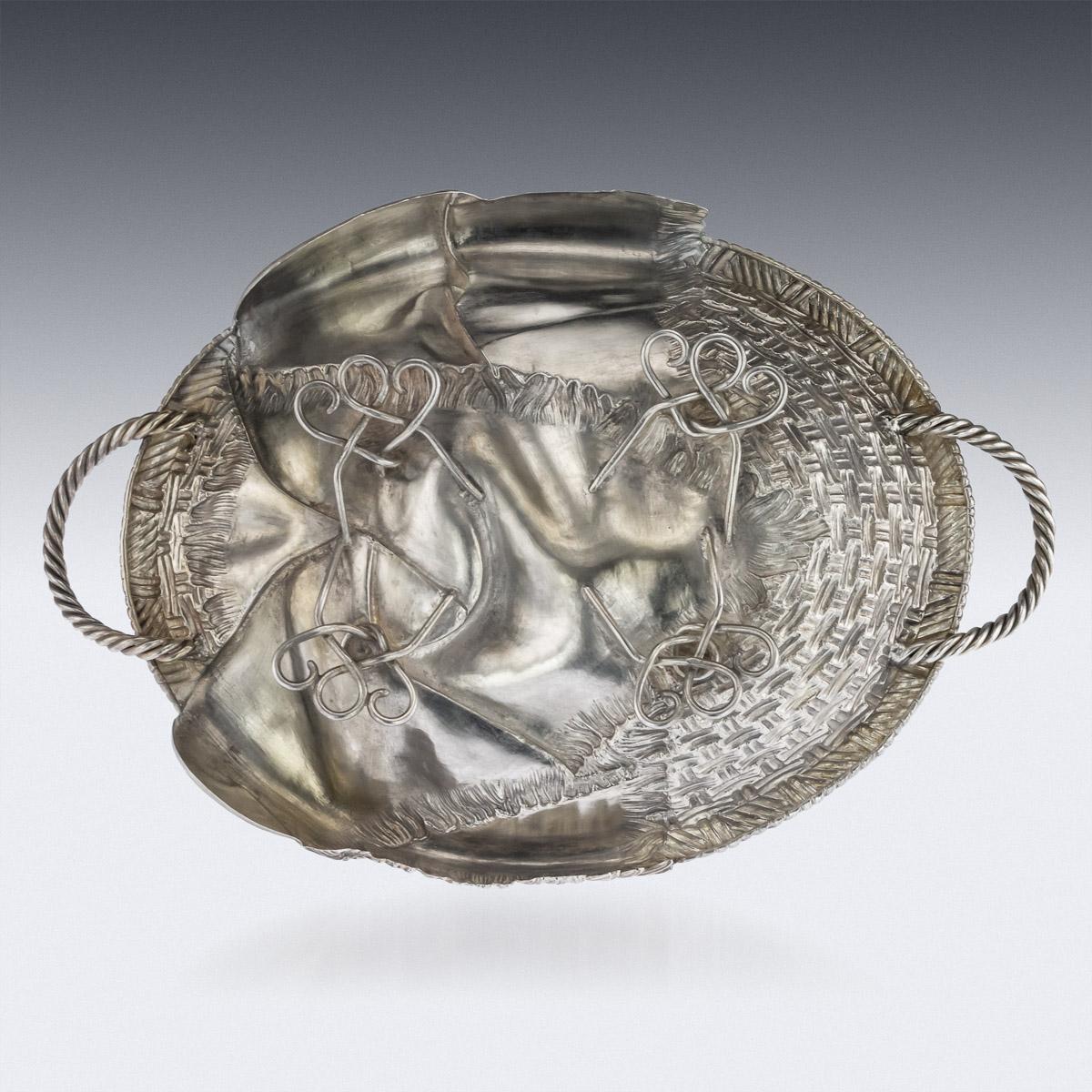Antique 19th century Russian solid silver trompe l'oeil bread basket, very large and of heavy gauge, of oval form, embellished with a fringed cloth, flanked by a pair of ropetwist handles and raised on wirework feet. Hallmarked Russian Silver 84