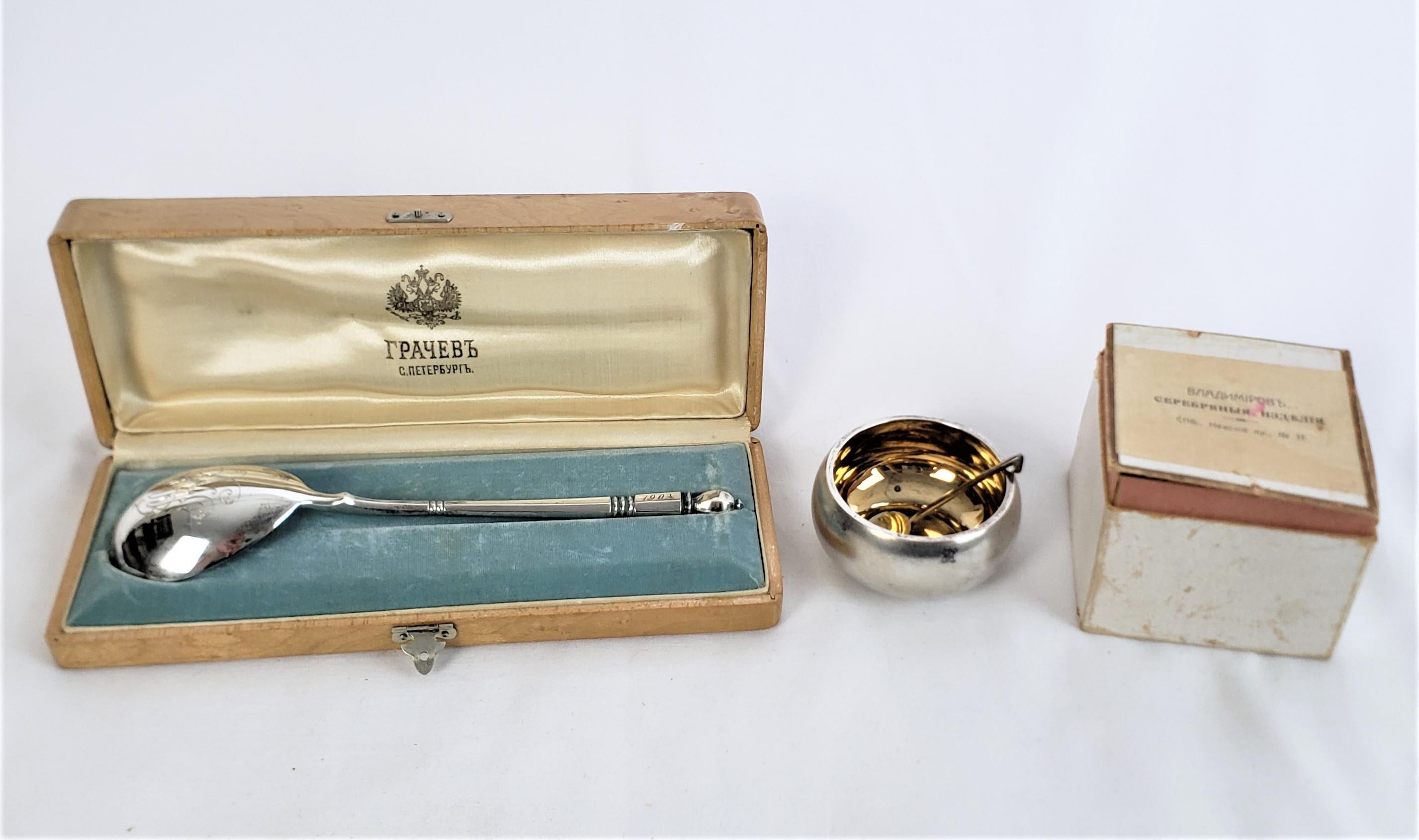 This pairing consists of an antique Tsarist Russian serving spoon with a fitted case and an antique Tsarist Russian open salt cellar and spoon with its original cardboard box. The spoons and salt cellar date to approximately 1903-1910 and are done