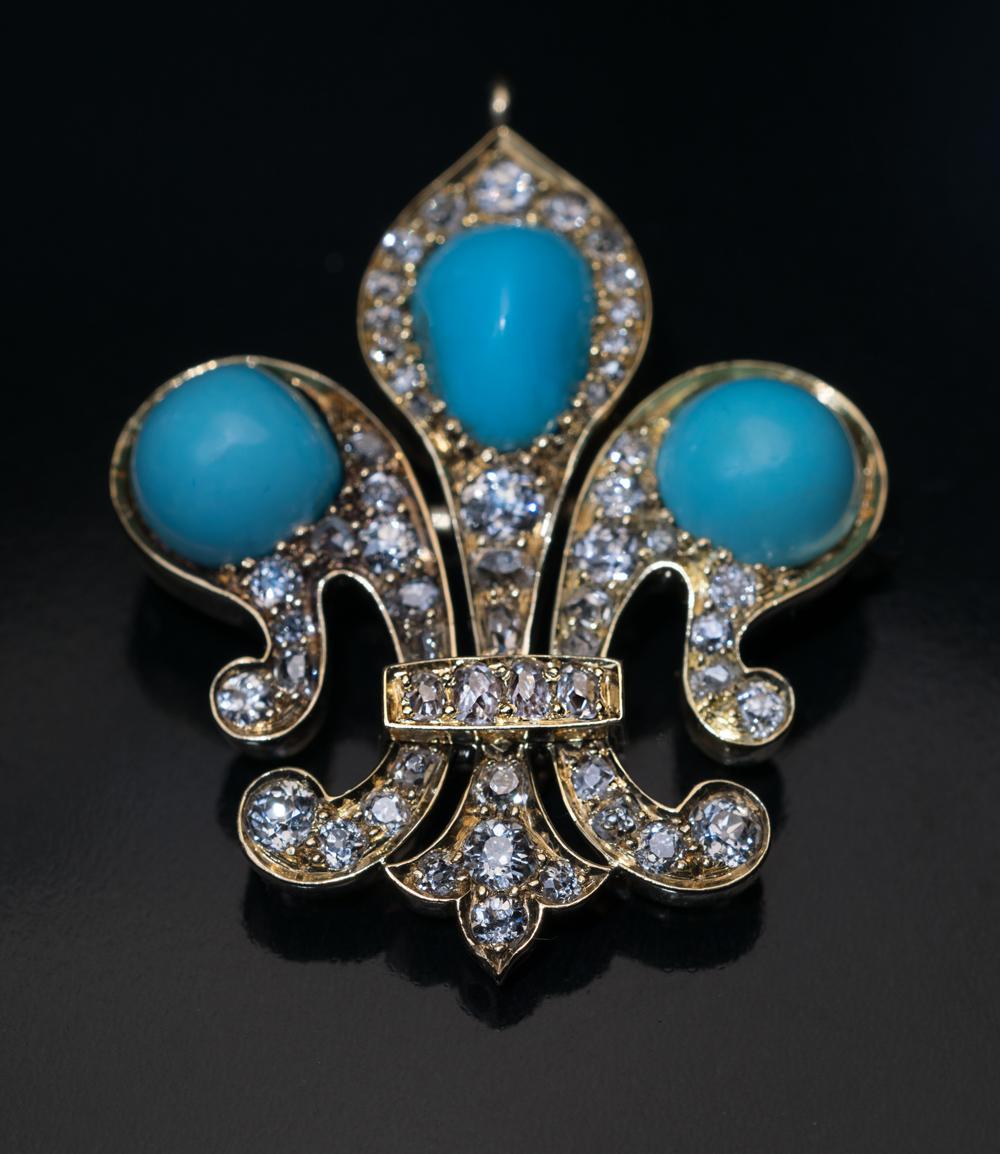 This antique Victorian era turquoise necklace was made in St. Petersburg in the 1880s. The necklace features a finely crafted 14K gold fleur-de-lis pendant embellished with turquoise and old mine cut diamonds. The bail is set with rose cut