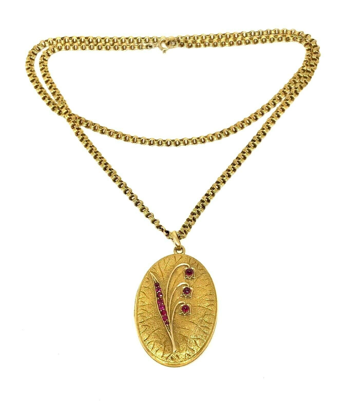 Beautiful antique (circa early 1900s) Russian chain necklace with a locket pendant, both made of 10k yellow gold. The locket features eleven rubies accentuating the lily of the valley image: three cabochon and eight round cut.
Measurements: the
