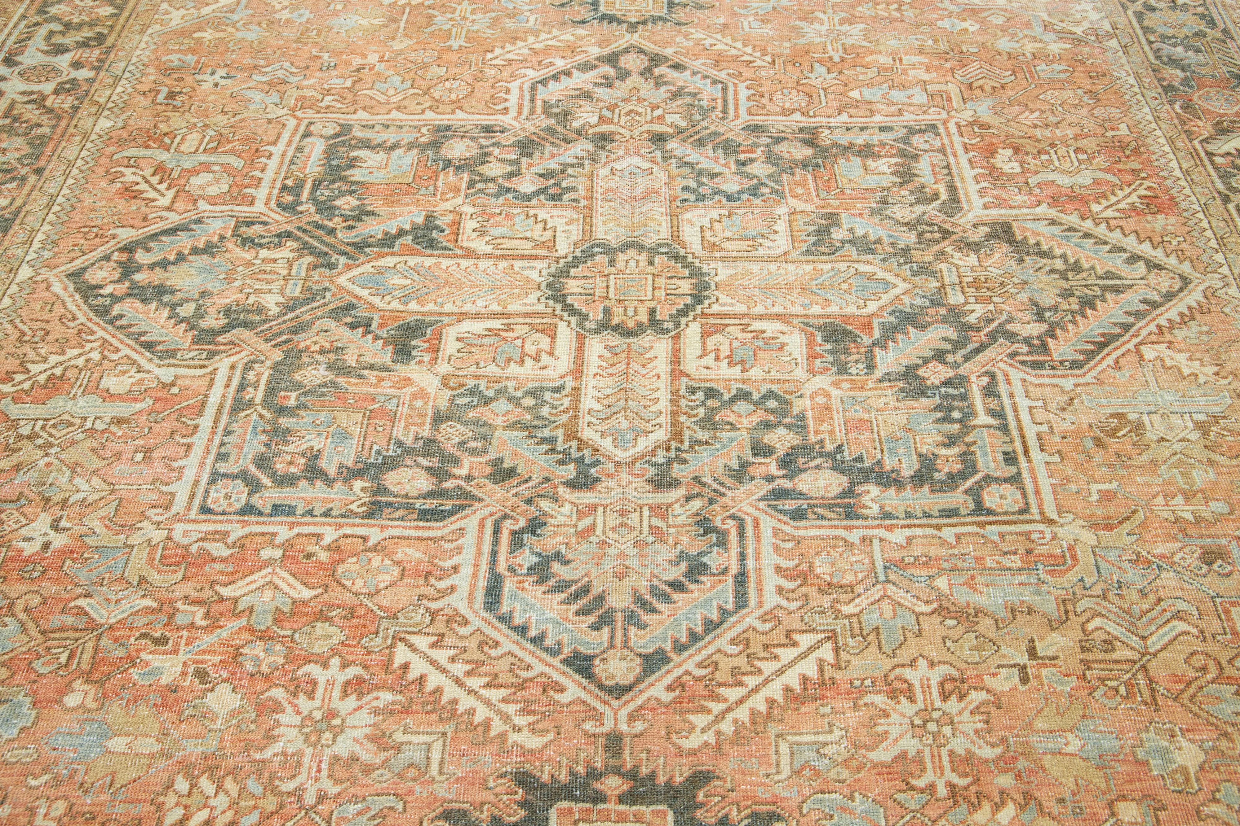 Early 20th Century Antique Rust Persian Heriz Wool Rug Featuring a Medallion Motif For Sale