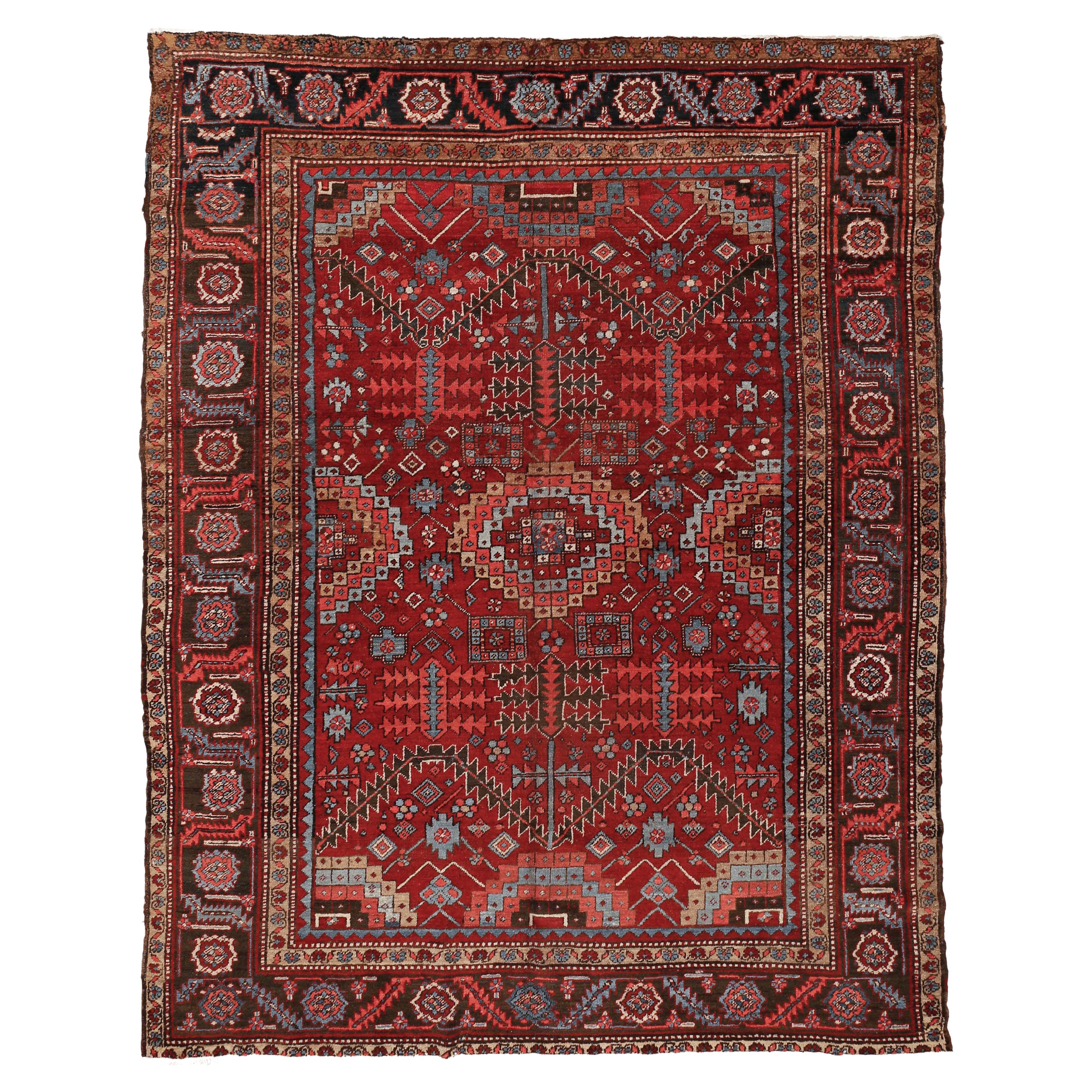 Tapis Heriz rouge rouille ancien avec motif sur toute sa surface de feuilles et de palmettes stylisées