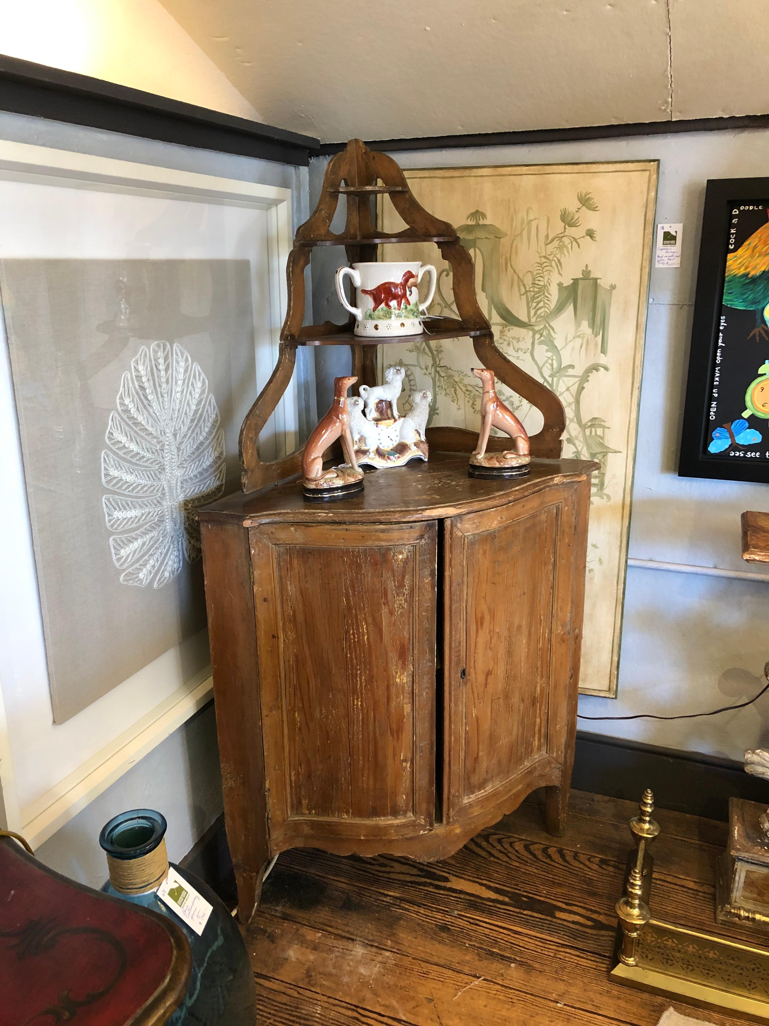 Wonderful antique weathered two-piece corner cabinet having storage in the bottom and pretty shelves on top. Charming distressed condition intentionally in authentic condition.
Bottom is 36.25 H.