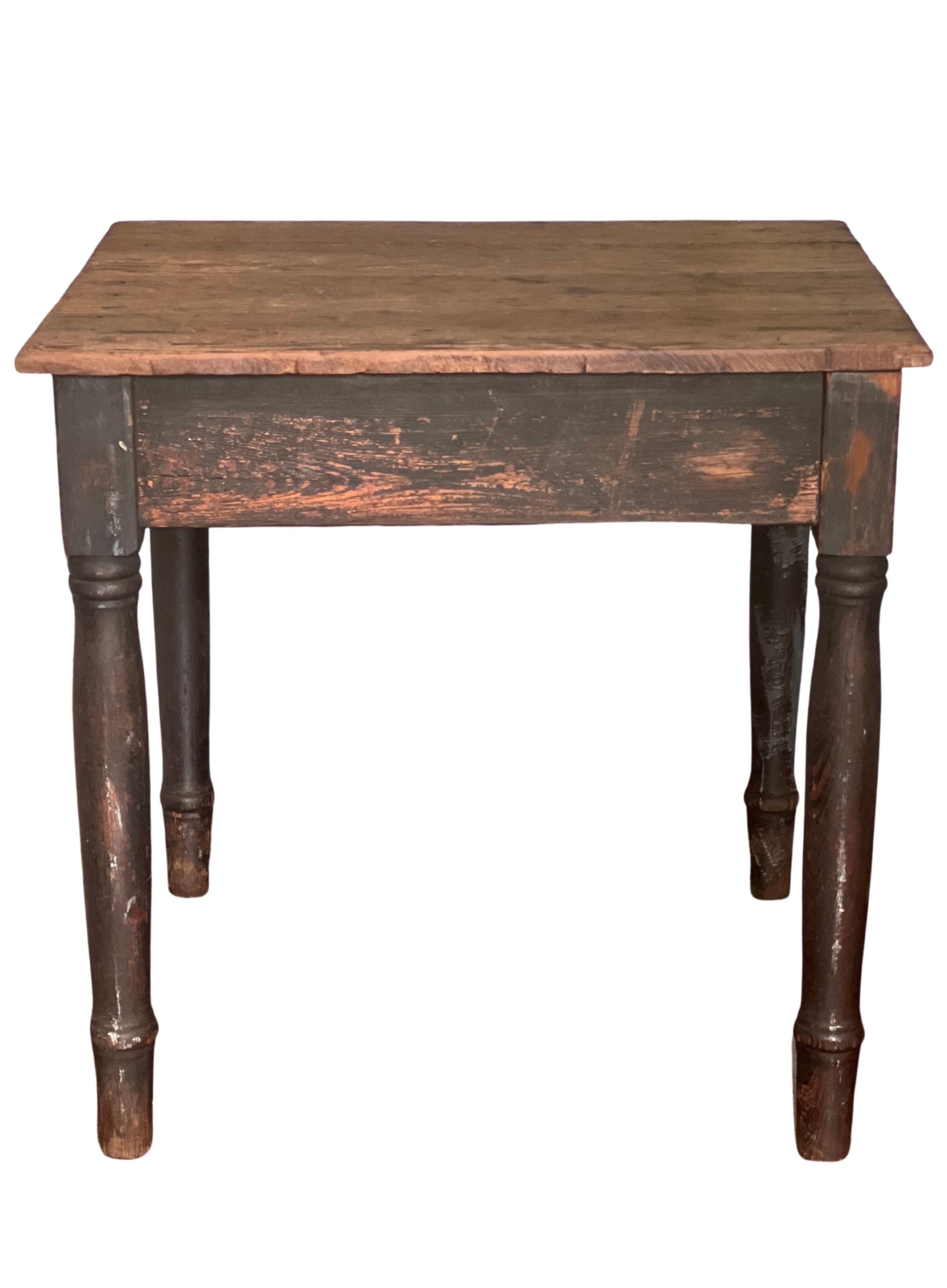 Antique rustic black painted Farmhouse harvest work table, c. 1900.

Gorgeous, super sturdy work table beautifully patinated with original, aged black paint. Wonderful color in a warm, muted black having a naturally distressed finish acquired