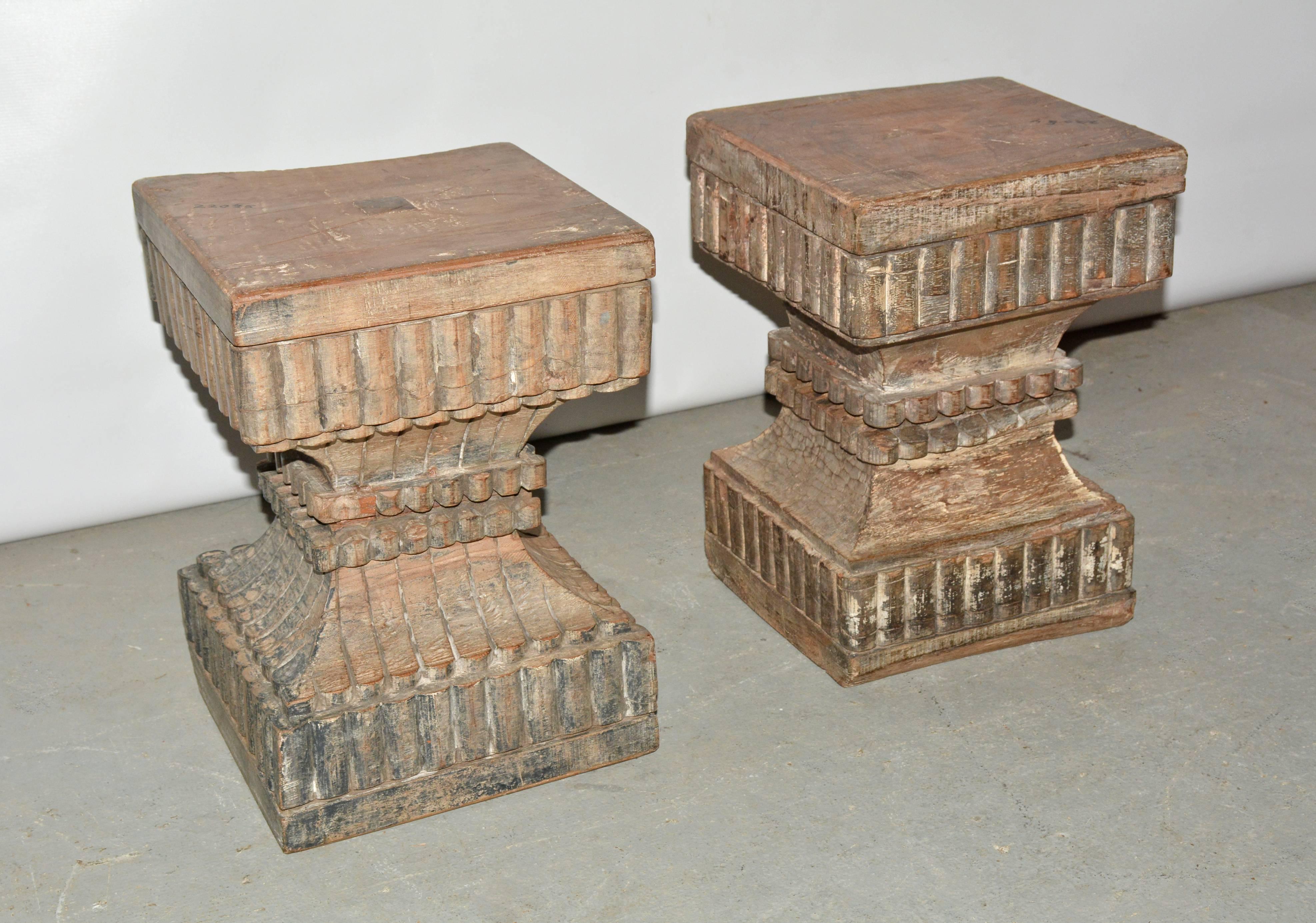 Two very similar Indian carved wood pedestal, plinth, table bases or stools. Beautifully hand carved with wonderful wood patina showing paint remnant giving them wonderful patina and character. Once part of a column, reduced to a size usable as end
