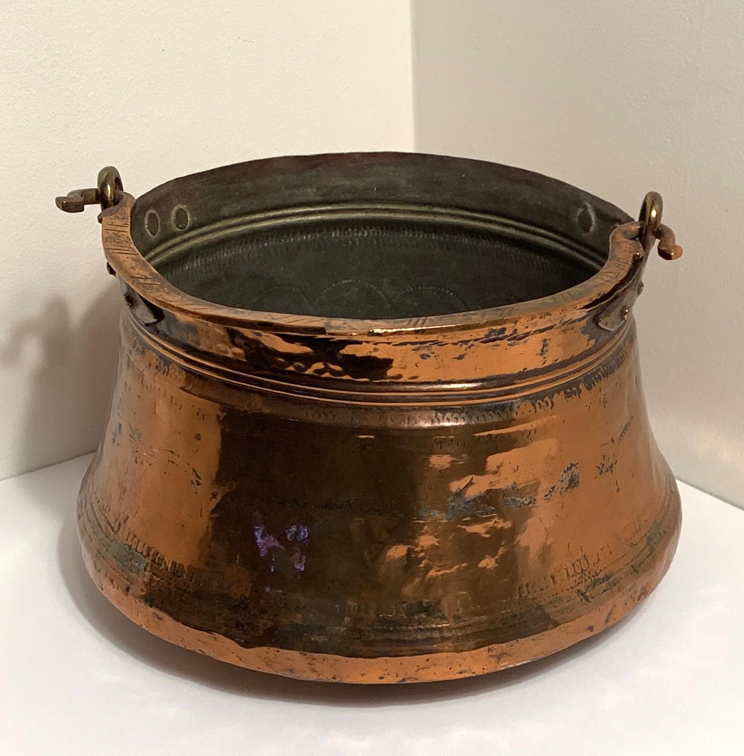 Hand-hammered Antique Rustic Copper Cauldron w/Handle 

Perfect for fireplace kindling, wine cooler at your next garden party, planter, towels, halloween candy, etc. Or actually use it for what it was made for, to cook on your fireplace hearth