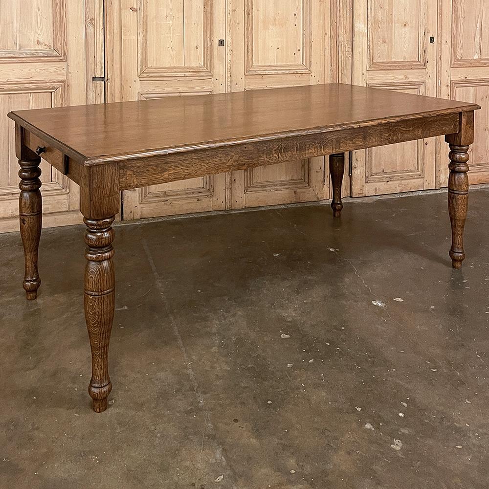 Antique Rustic European oak dining table was fashioned with a time-honored design using fine old-growth oak to last for decade after decade! The heavy beam legs were turned into a pleasing elongated urn form to add a little gracefulness to the