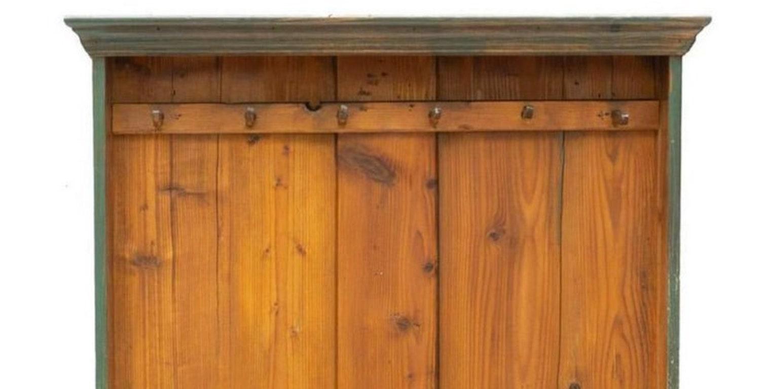 A rustic, antique farmhouse distressed painted hall tree. American primitive, medium pine wood slatted planks, with six pegs for hanging jackets and hats, having a distressed green back and sides. Wonderful for any foyer, mud room, patio, entry to