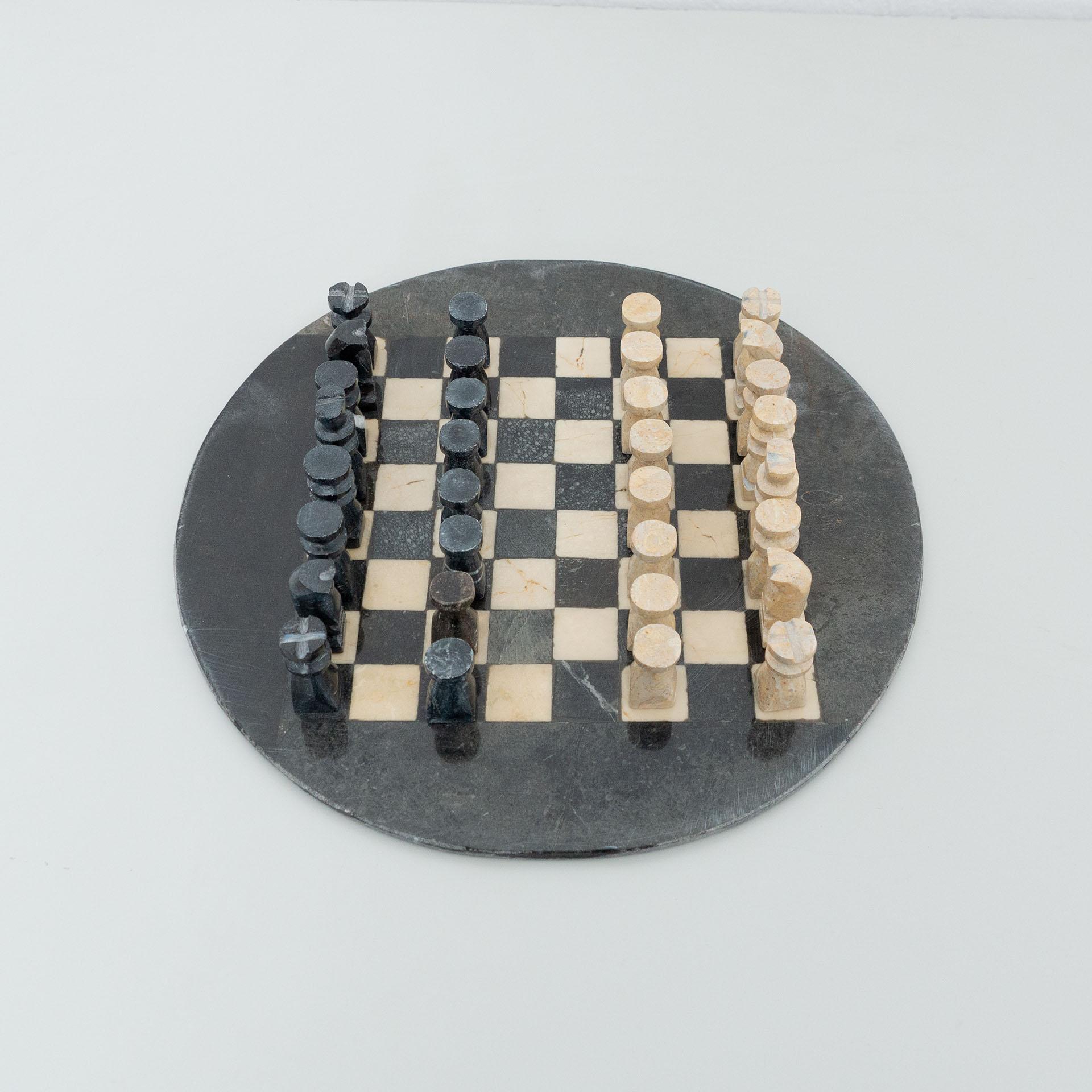 Antique rustic stone chess.
By unknown manufacturer from France, circa 1940.

In original condition, with minor wear consistent with age and use, preserving a beautiful patina.

Material:
Stone

Dimensions:
ø 34 cm x H 6.8 cm.