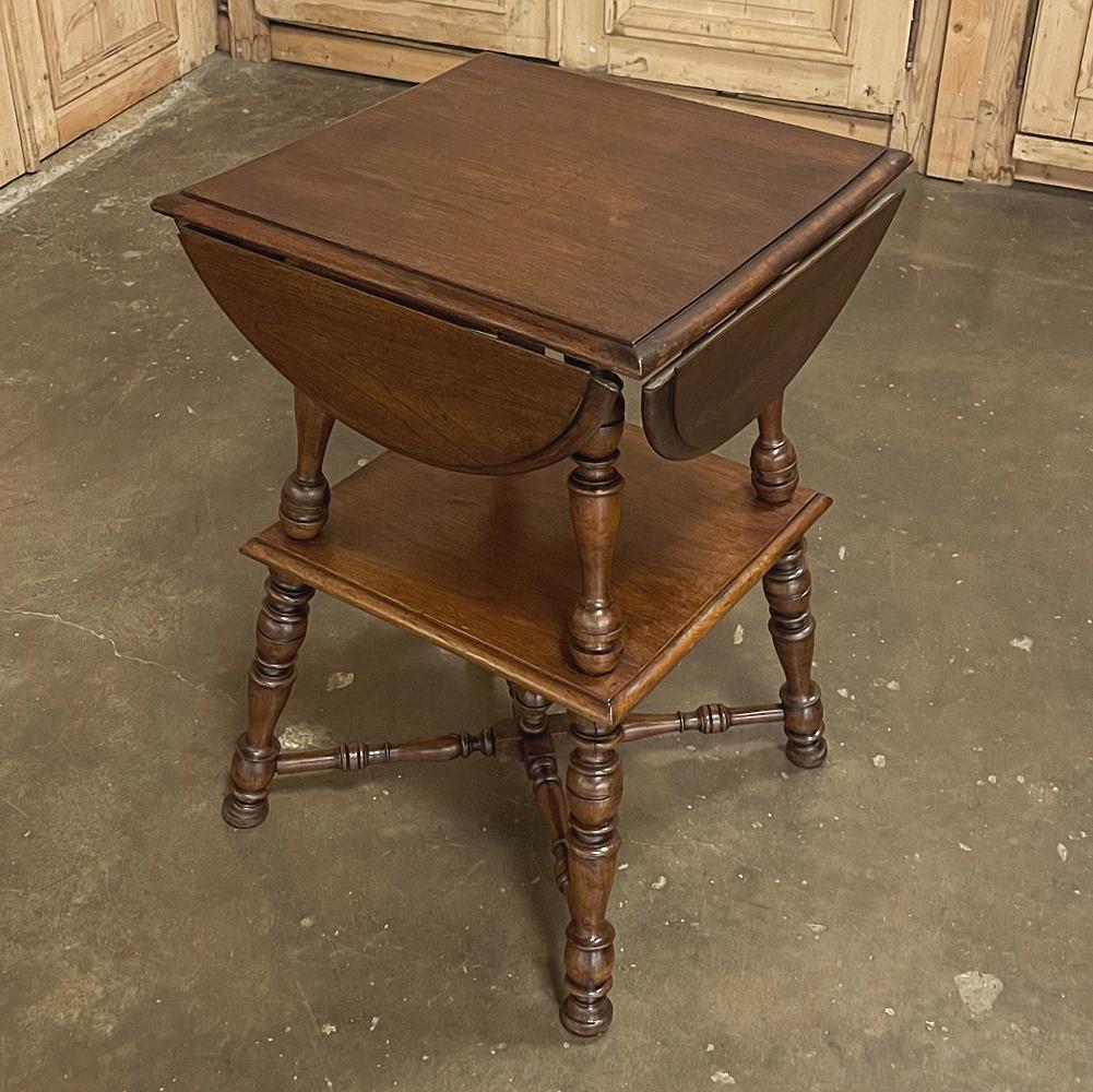 Antique Rustic French walnut drop leaf end table is a unique example of ingenious craftsmanship! When folded, it creates a diminutive end table that can be used with seating groups, for a lamp, and pretty much any room. The turned legs are in two