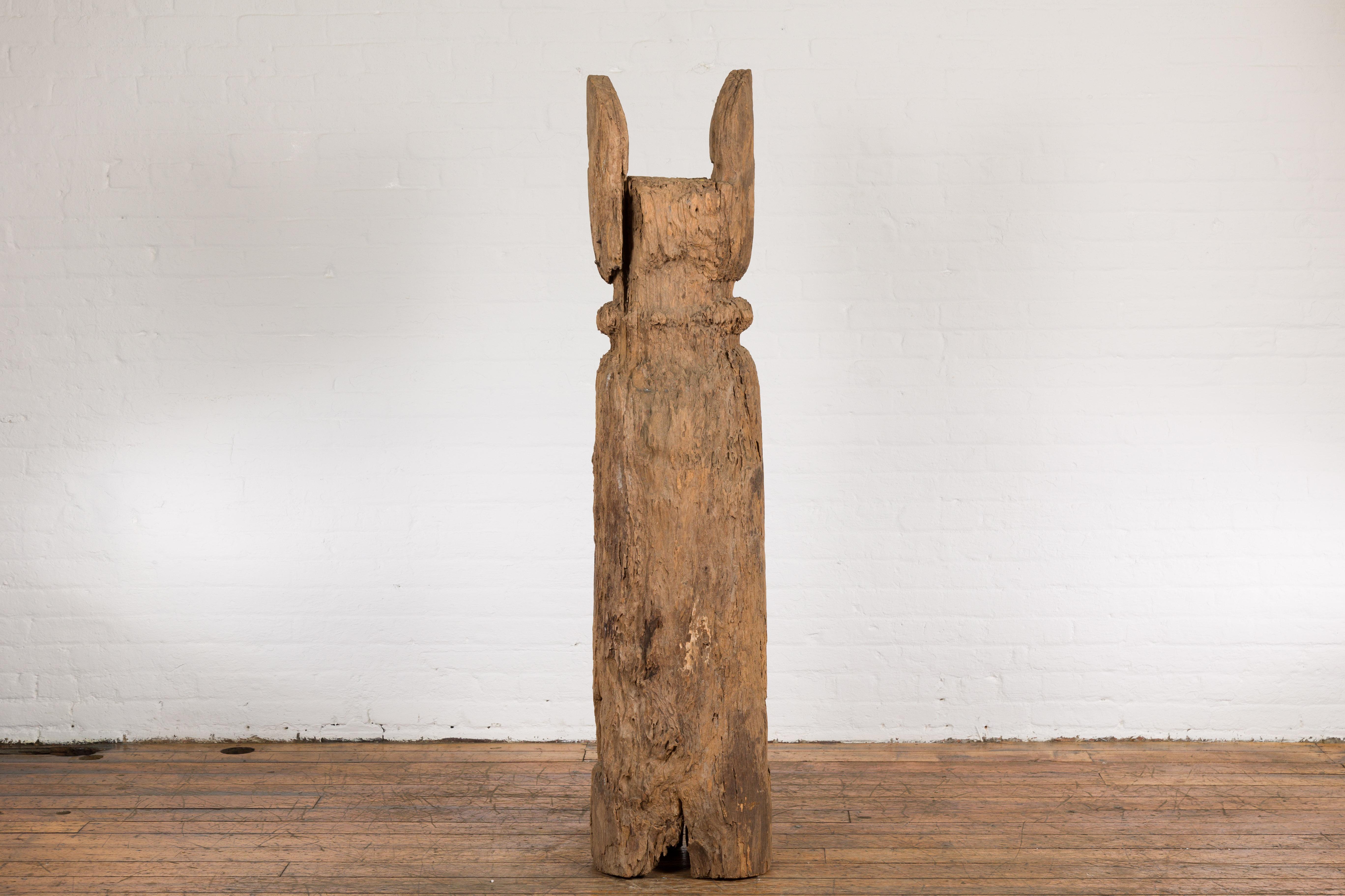 A Tribal antique 19th century rustic hand-carved Thai pole sculpture from the mountainous city of Chiang Mai, featuring a natural patina. Experience a touch of Thai history with this rustic, hand-carved pole sculpture hailing from the mountainous
