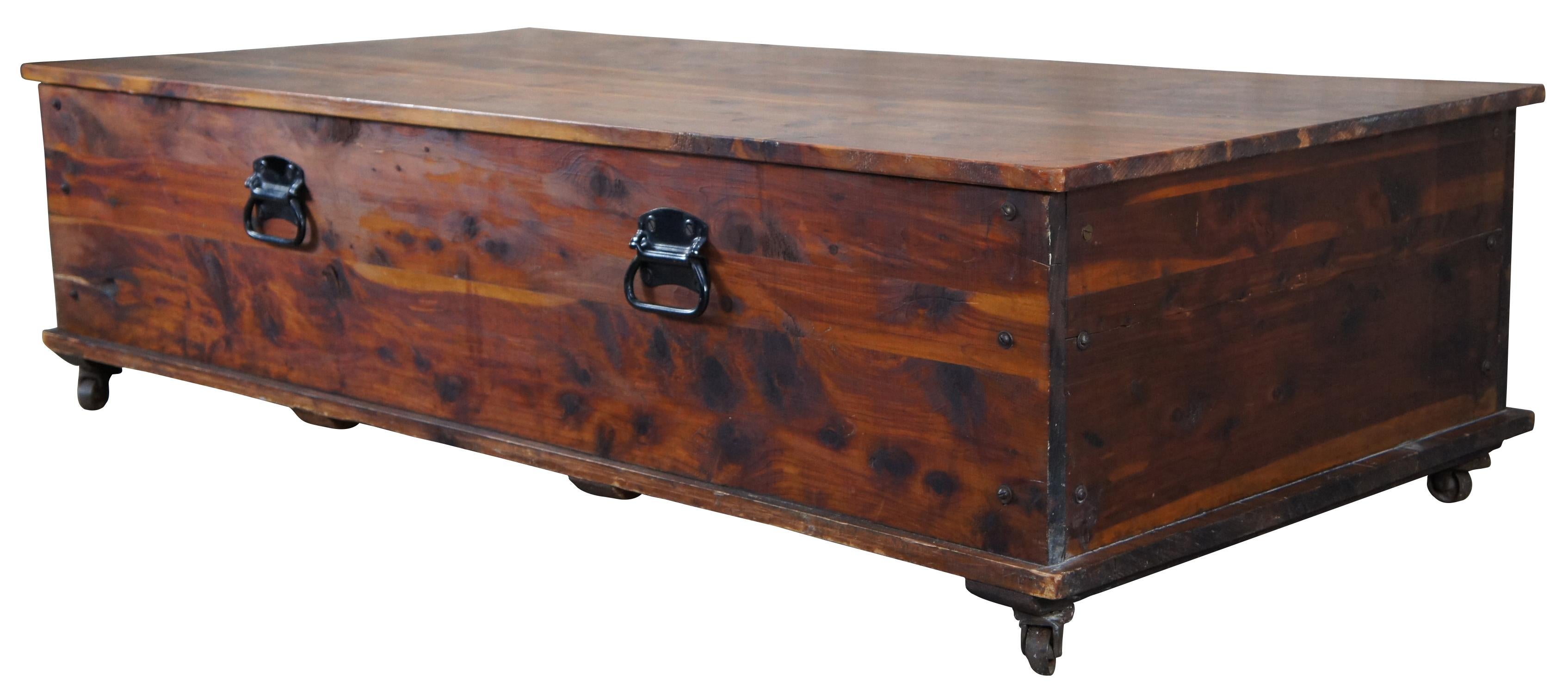 A large beautiful coffee table or storage chest, circa 1940s. Rectangular form with iron hardware and industrial casters.
 
