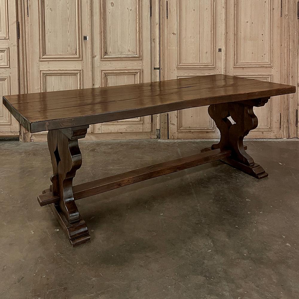 Antique Rustic Italian Style Trestle Farm Table was hand-crafted using traditional methods handed down from generation to generation.  Utilizing thick planks and timbers of old growth solid oak, the artisans formed the sturdy top from four planks,