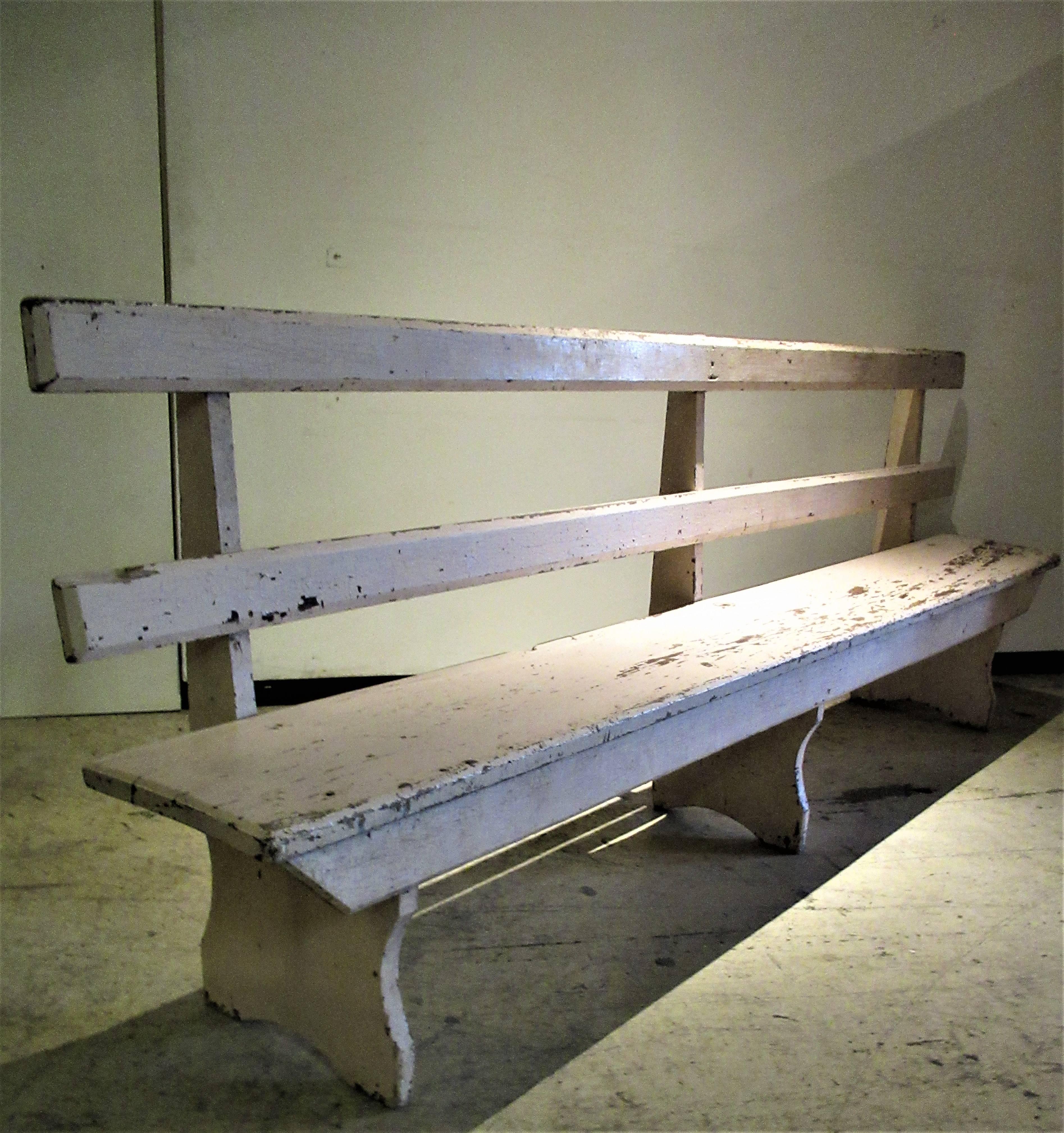 Antique Primitive rustic pine bench seat with two back rails in all-over old pale worn painted surface and early square nail construction. Beautiful elongated sculptural form with a modernist like aesthetic. Solid as a rock. Ontario, Canada in