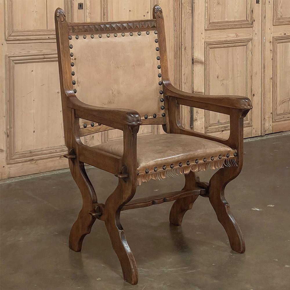 Antique Rustic Neogothic armchair was constructed from thick, solid oak to last for generations, and includes a fine leather upholstery affixed with brass tacks for a truly timeless look! The Gothic style originated in the middle of the 12th century
