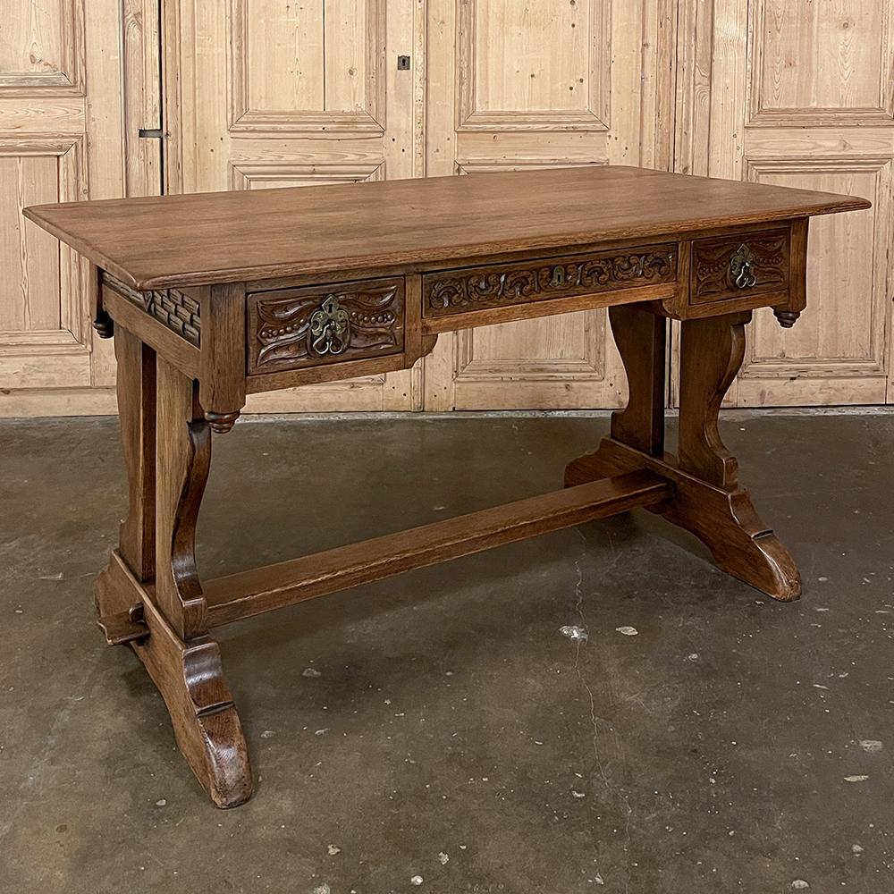 Antique Rustic Neogothic desk ~ writing table is a sturdy, timeless design made for daily use and enjoyment. Hand-crafted from solid planks of oak, it features a generous overhang and a single tier of three drawers, with carved detail on all four