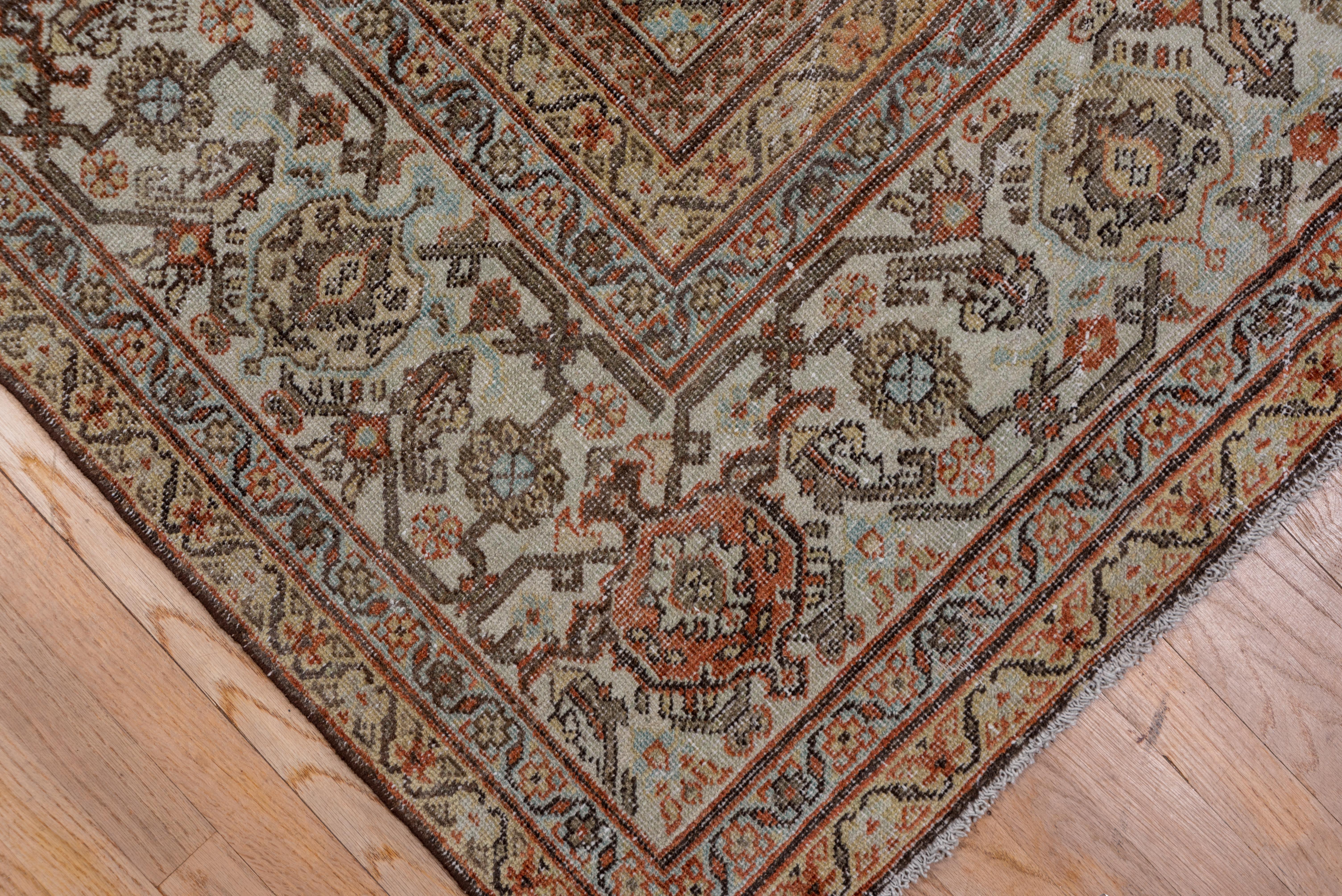 Herati green corners and beige stepped diamond medallion, tomato madder red Gol Hennai allover pattern field. Ivory turtle palmette and lancet leaf border. A totally classic West Persian rural carpet.
  