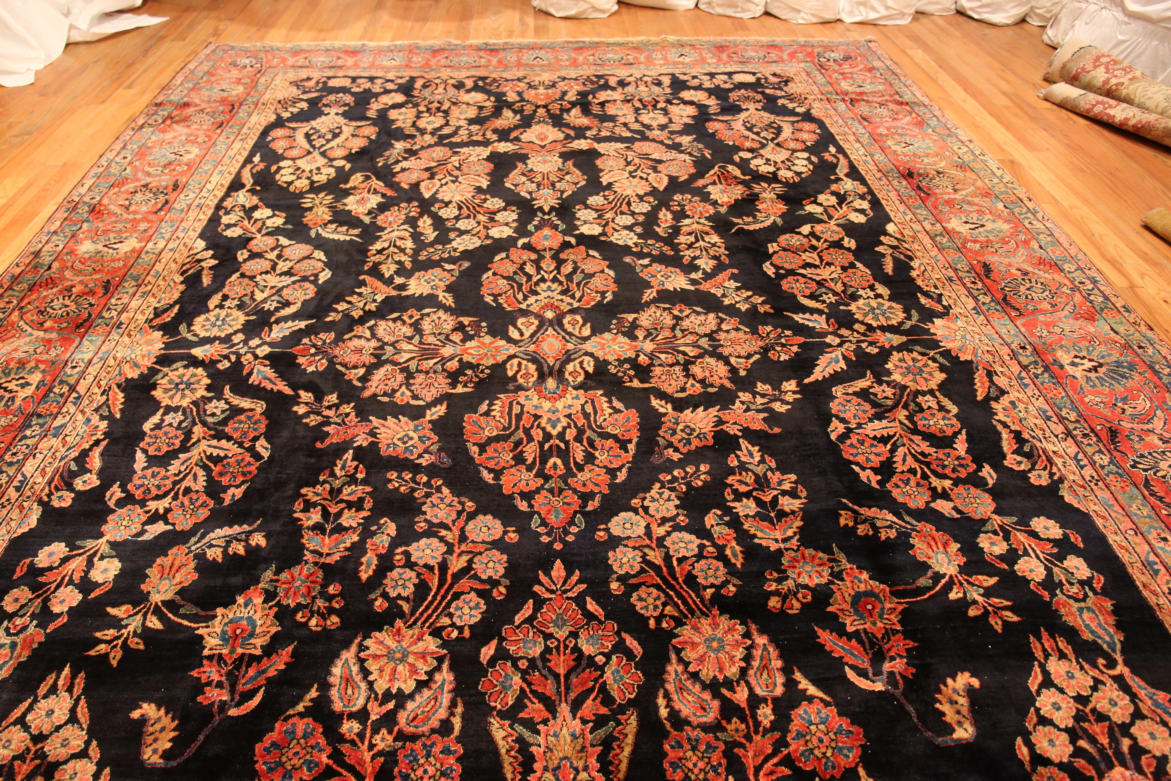 Bold Beautiful Fine Large Size Floral Antique Rustic Persian Sarouk Rug, Country of origin: Persian rug, Circa date: 1920. Size: 11 ft 4 in x 17 ft 4 in (3.45 m x 5.28 m)