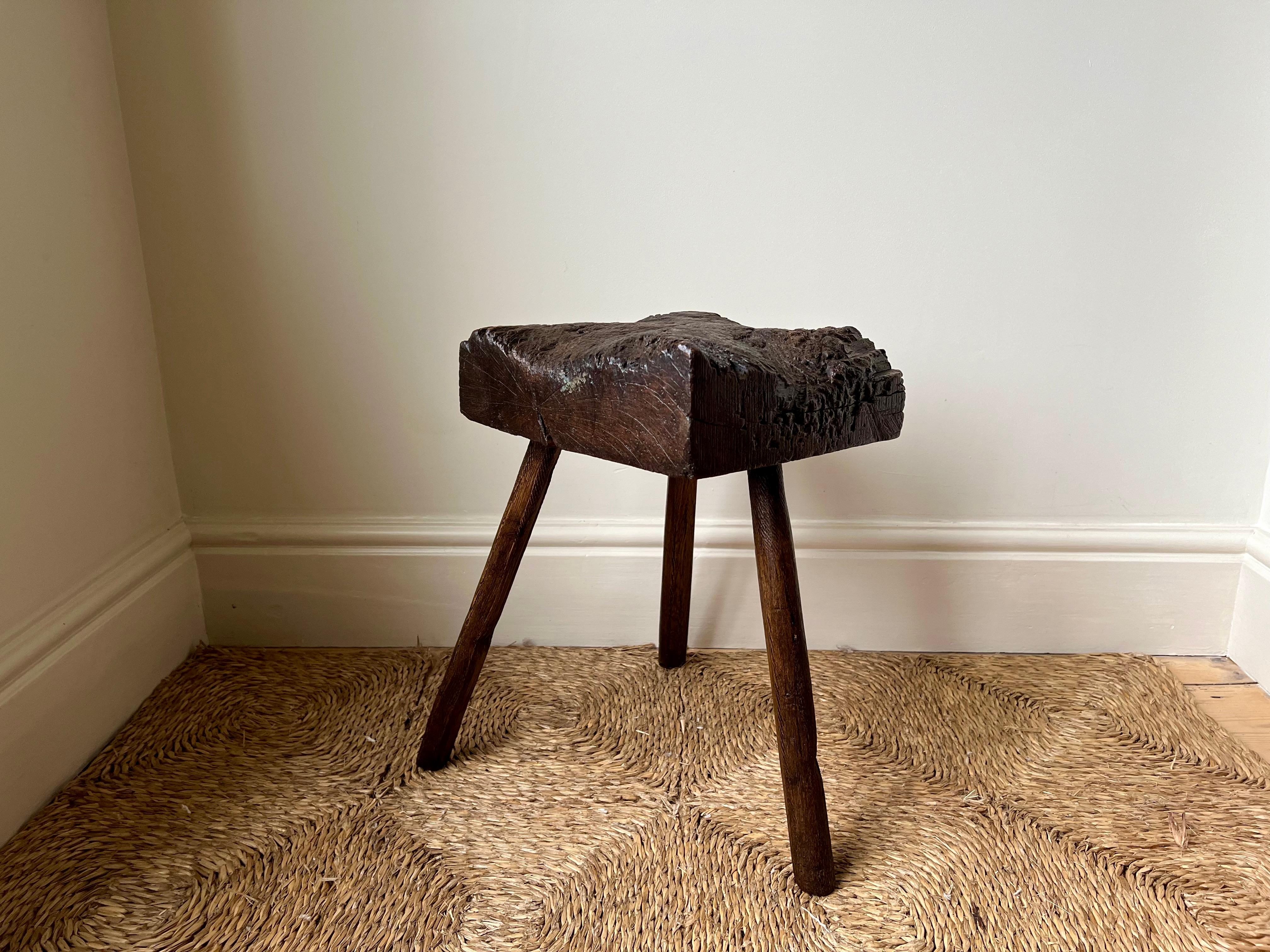 18th-19th century rustic thatcher's tripod stool from rural Devonshire, England.

Primitive rustic construction. The slabbed elm wood chunky top showing a century or two of wear and use giving it a unique shape and superb aged patina. 

Good size,