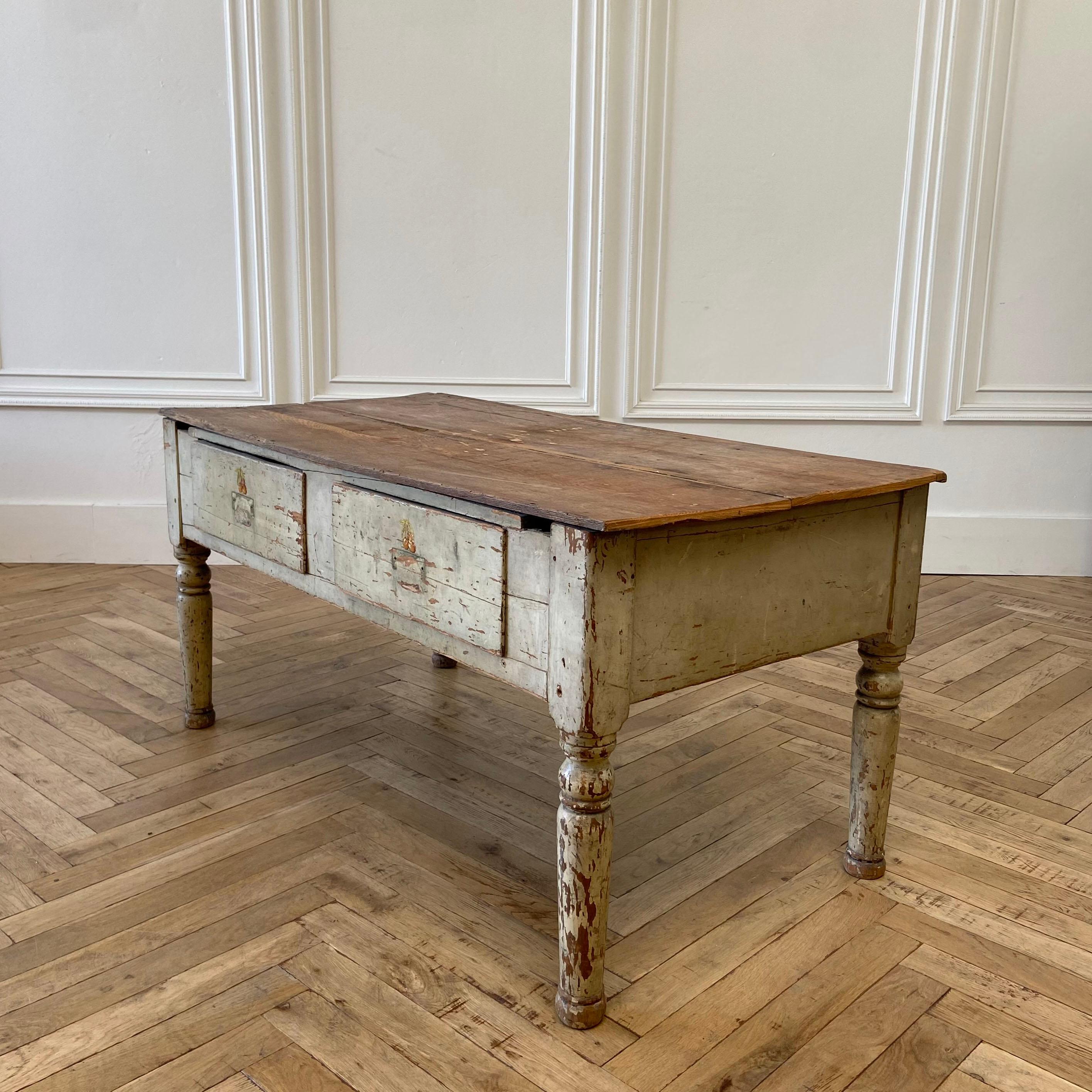 Antique rustic primitive style low table or coffee table.
Original painted legs and finish is very distressed. Drawers open and close with ease, there are stencils on the face of the drawer that can be removed or sanded away if wanted.
The legs