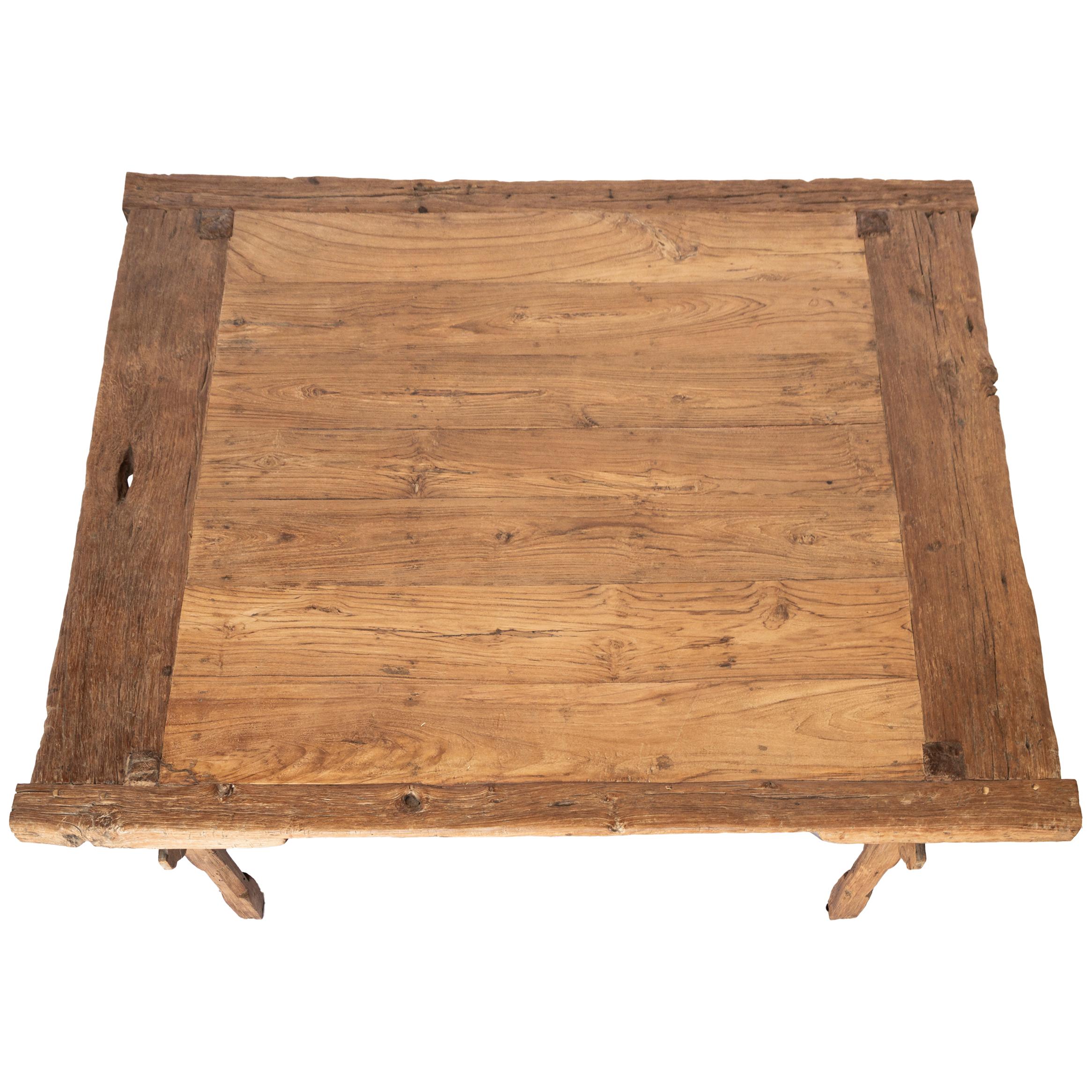 This large-scale coffee table embodies wabi-sabi style with its hand-carved joinery, weathered wood tone, and aged patina, adding character and rustic charm to its timeless appeal. 
Wear is consistent with age and use. See photos for details.