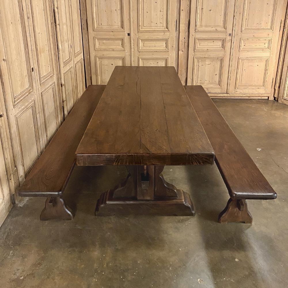 Antique rustic trestle table includes two benches was crafted from thick, solid timbers of sycamore wood, and literally designed to last for centuries! The heavy plank top is ably supported by equally heavy side structures that are affixed to bases