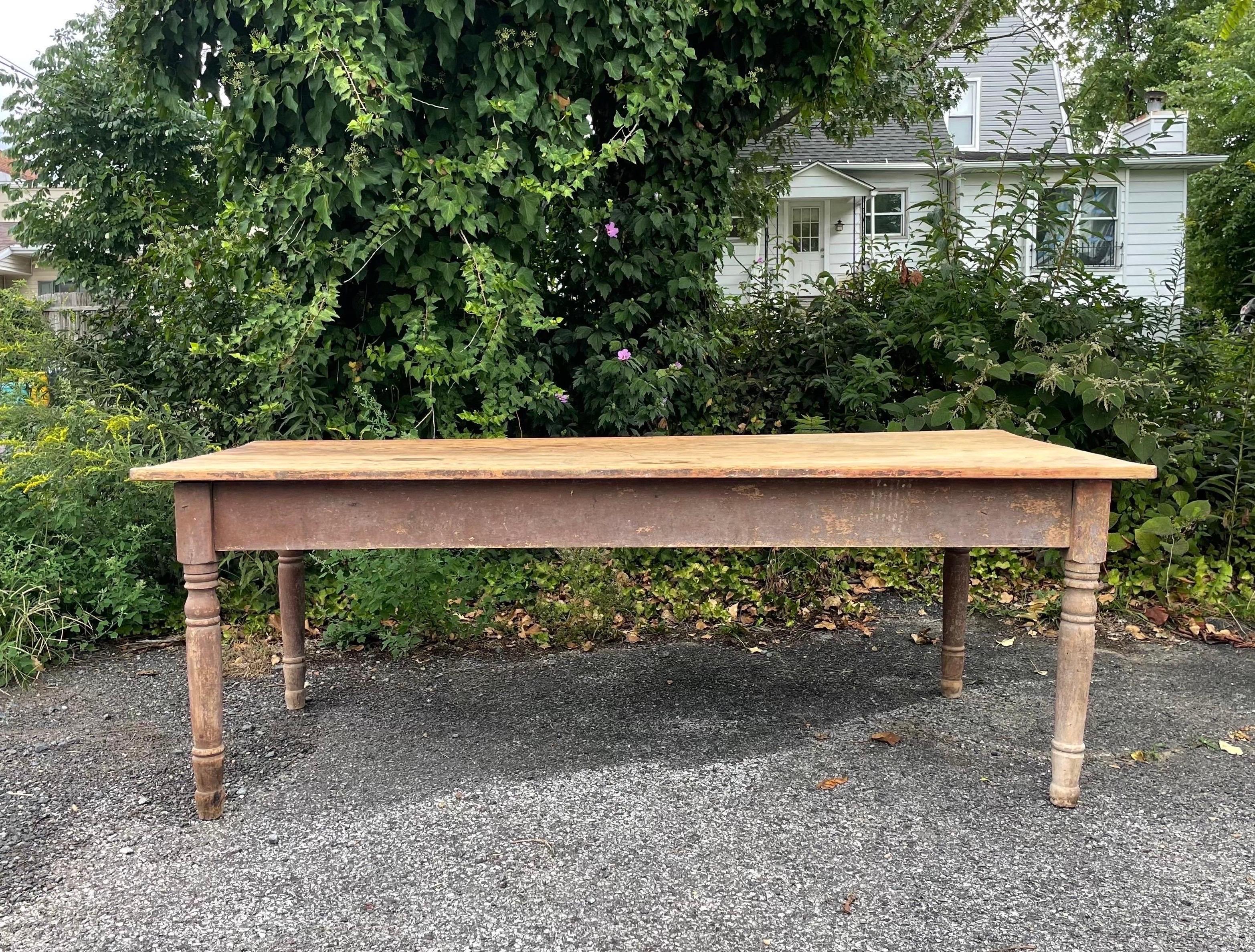 A primitive harvest or dining table made of old growth pine with tons of character and the widest boards I've ever seen (Imagine the size of that tree). Comfortably seats 8. Most likely from the early to mid 1800s.
