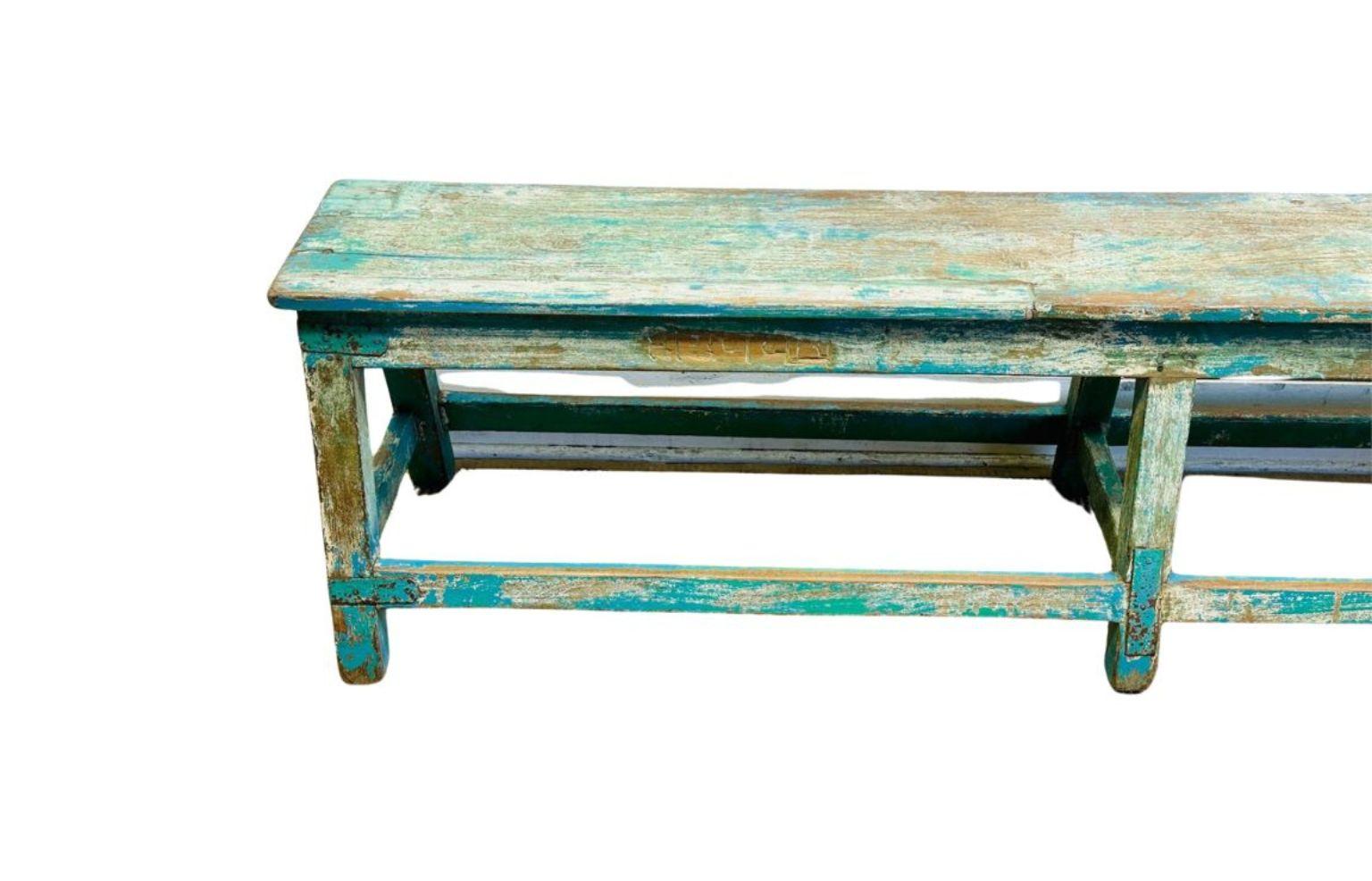Un banc en bois ancien magnifiquement vieilli, avec une finition peinte turquoise et sarcelle usée par le temps et des couches de patine d'origine. Ce banc rustique et primitif date du début ou du milieu du XXe siècle et offre un aspect authentique