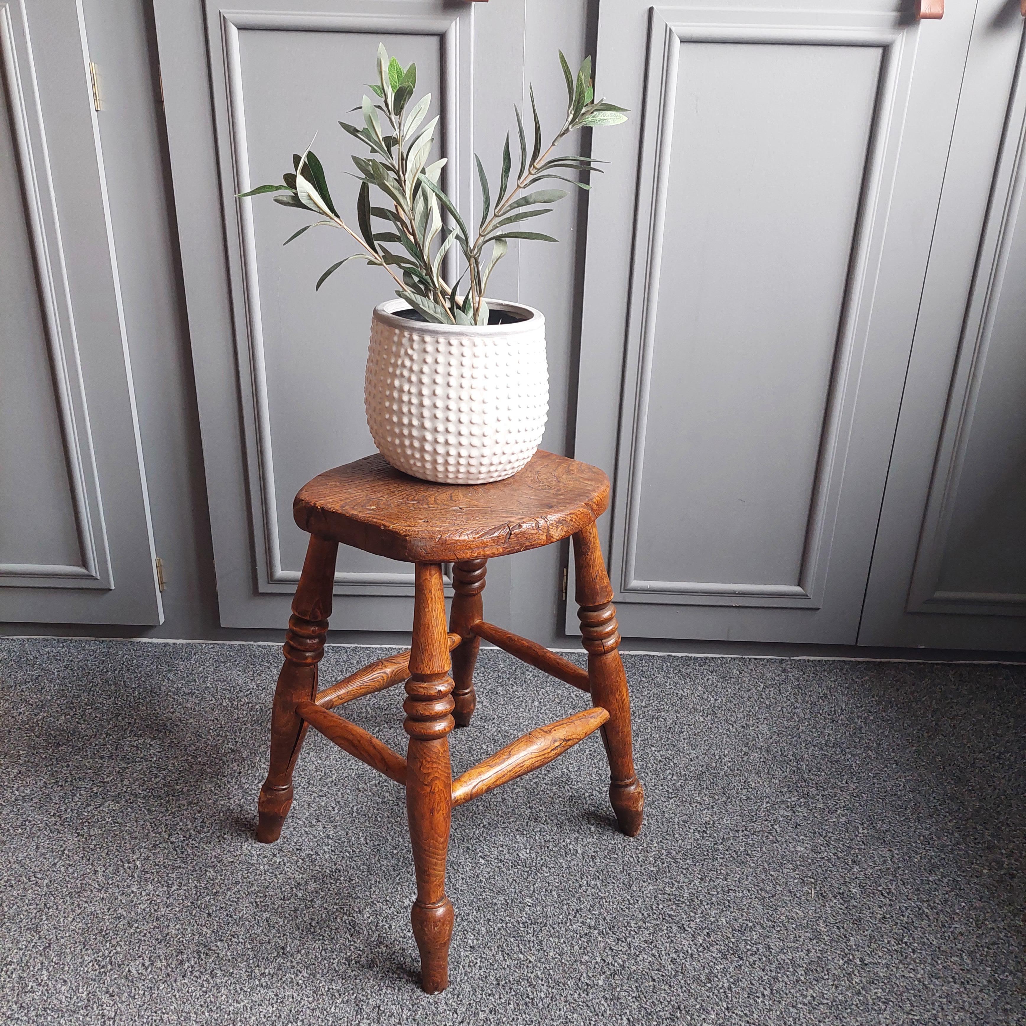 A lovely Victorian vernacular Elm stool.
Probably early 1900s

With marvelous age and wear.
Having ring turned legs and well worn seat.
Seat with nearly oval shape.
Four legged stools with stretchers

A great looking stool that would compliment and
