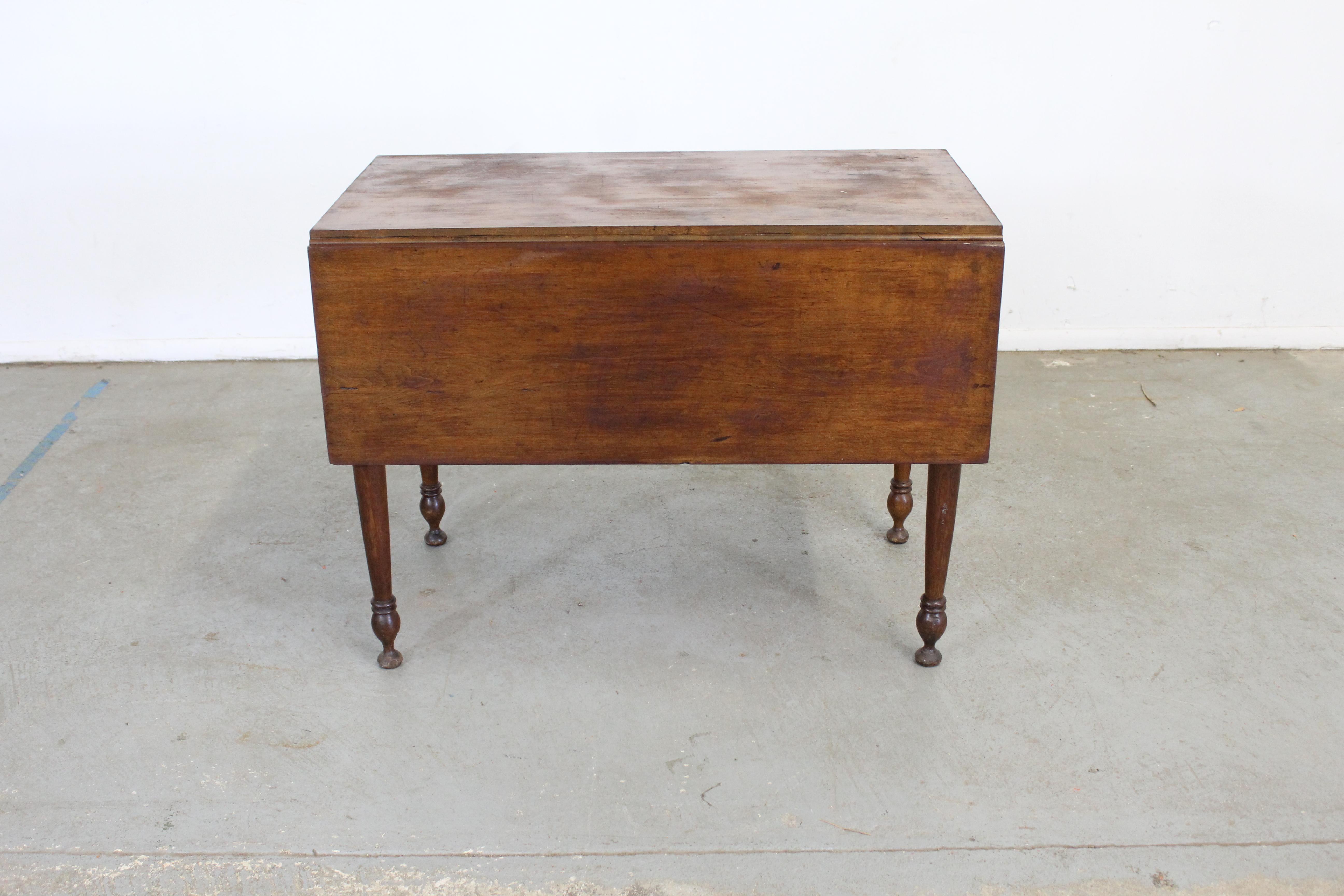 Antique rustic walnut drop leaf table

Offered is an antique drop leaf table. The table shows some scratches and age wear, the walnut shows fading and is in obvious vintage condition. It's made of solid walnut wood. It is not signed.