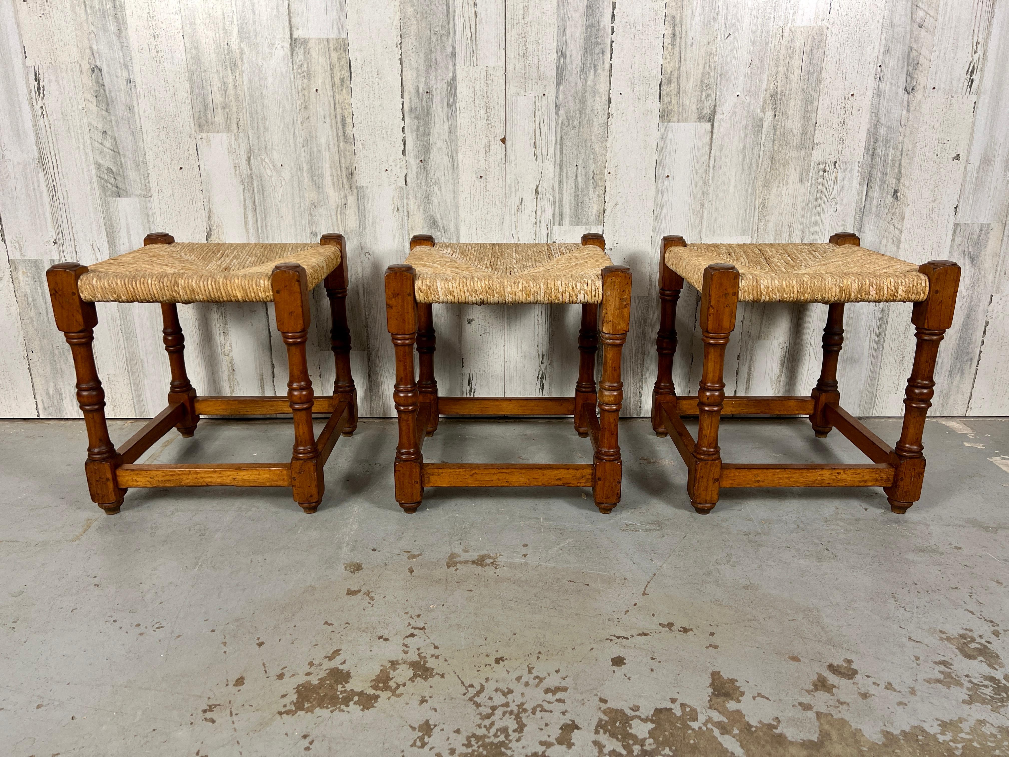 Rustic country French stools with woven grass rush seats,