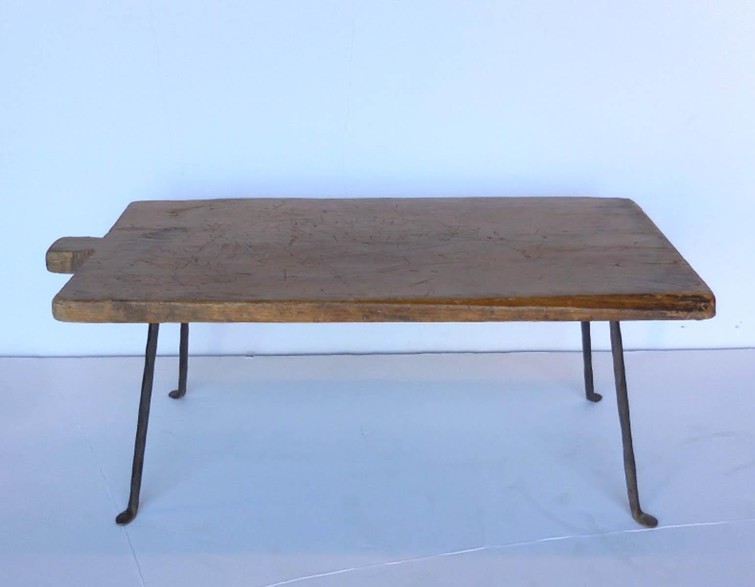 19th century wooden batea - tray - atop contemporary hand forged iron legs. Top  has been used and has a natural, beautiful patina, see photos.
Works well as a side table, nightstand or a small coffee table!