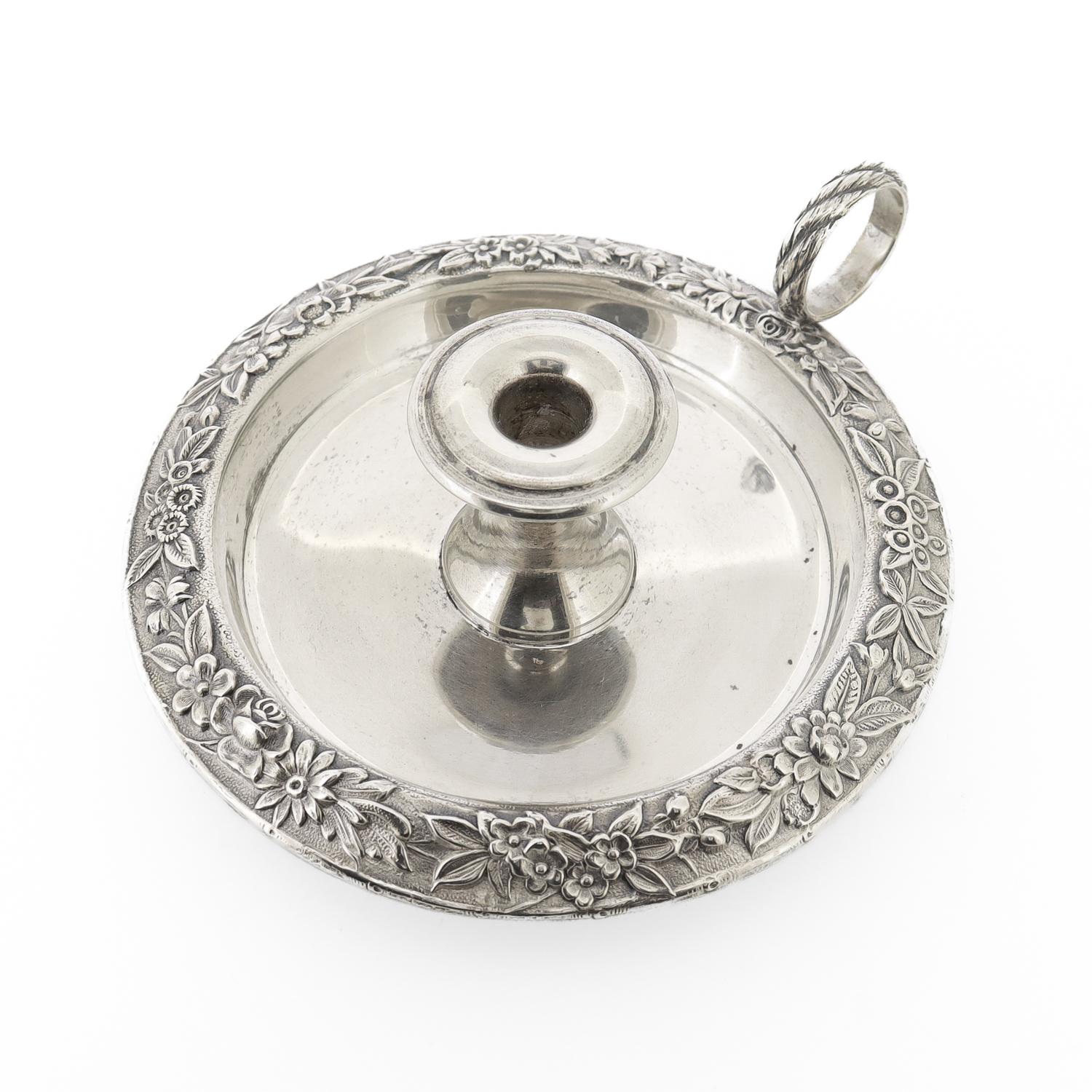 A fine vintage sterling silver chamberstick or candle holder.

By S. Kirk & Son.

With a circular wax pan decorated with repousse leaves and flowers around its rim.

Model no. 34

Simply a great chamberstick!

Date:
20th Century

Overall