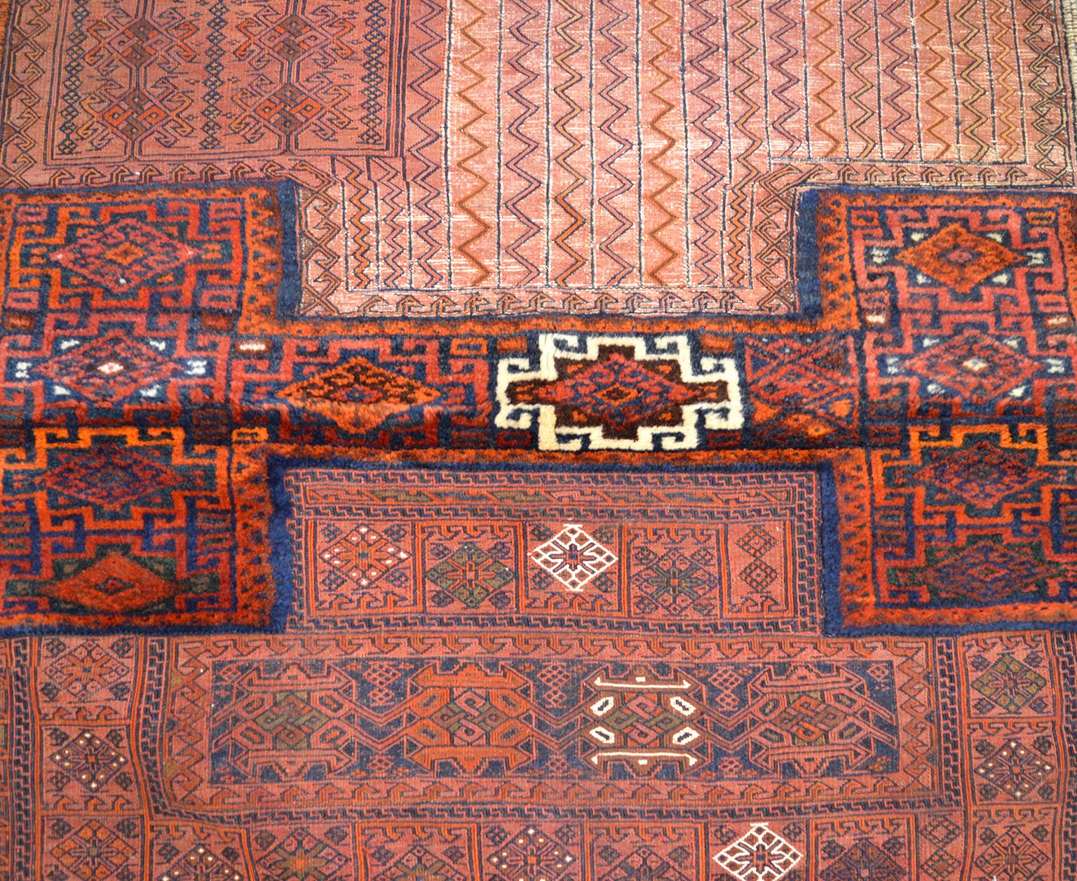 This antique saddlebag with Soumak and Bakhtiari Persian carpet weaves circa 1890 exhibits a colorful display of classic tribal geometric designs. The deep reds and blues contrast with cream outlines to create a unique interpretation of the