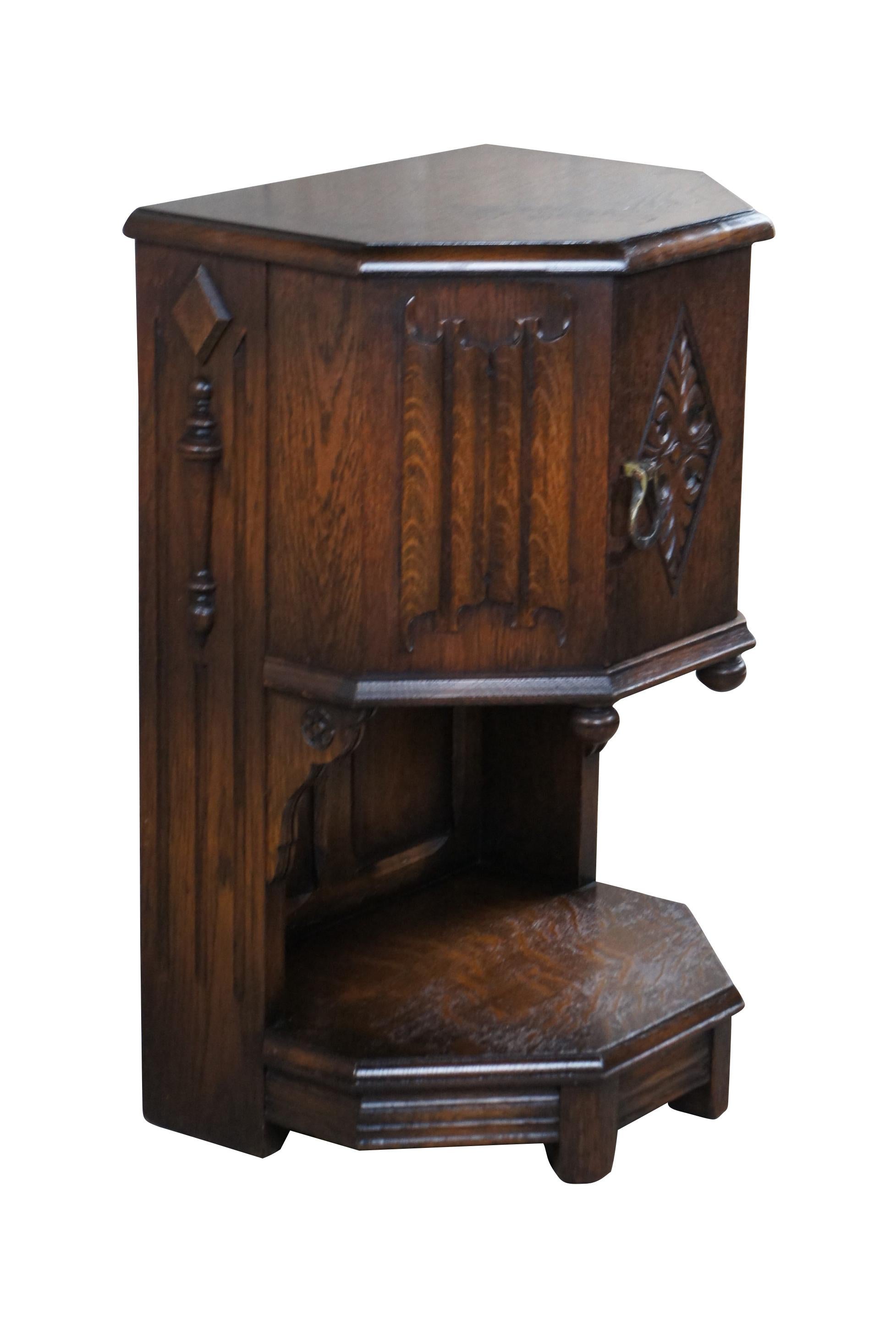 An impressive Spanish or Gothic Revival bedside table by Saginaw Furniture, circa late 1930s to early 40s. Made from oak with intriguing linen fold and diamond pattern acanthus carved accents.  Sides are accented by quarter cut turned and applied