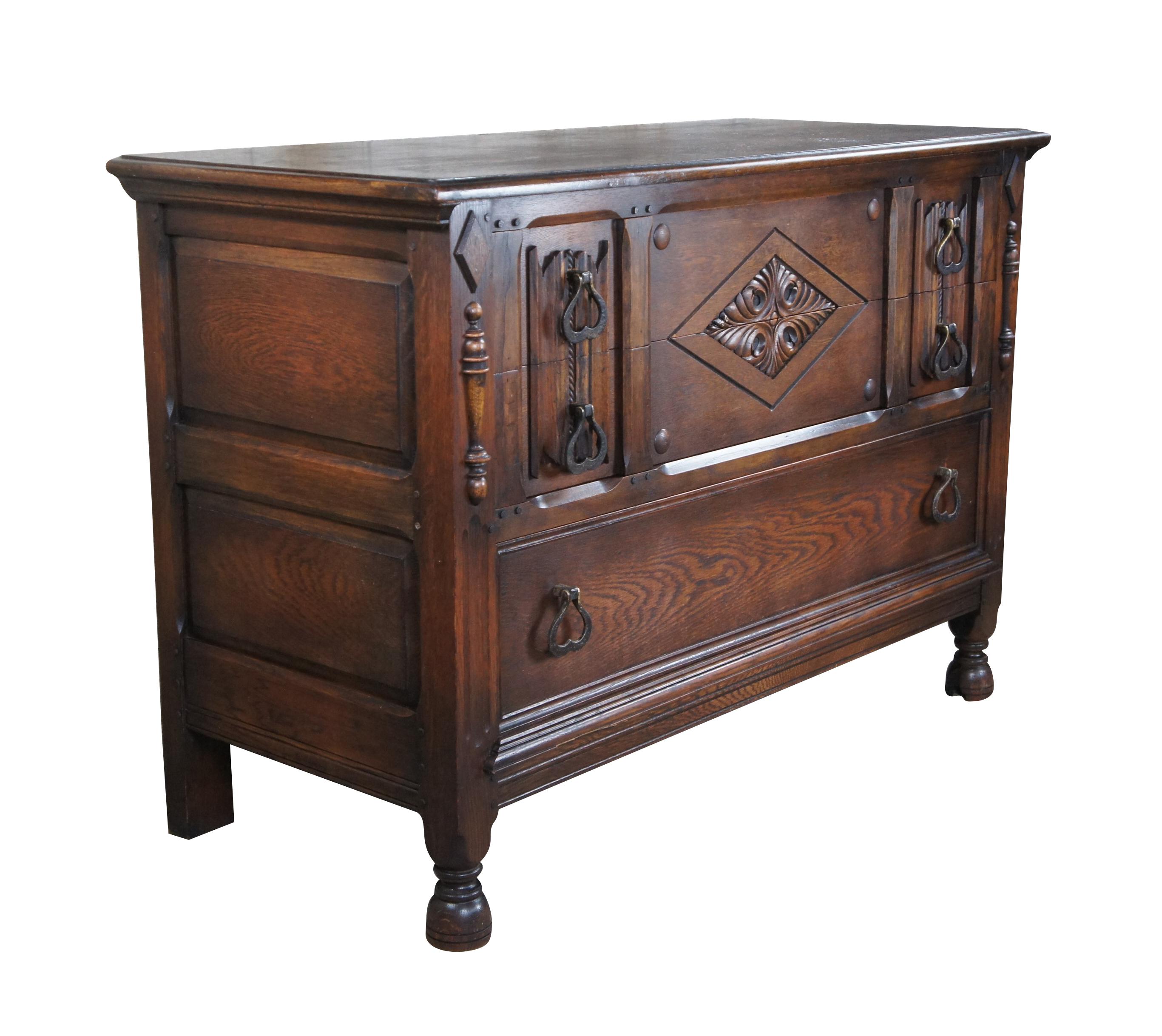 An impressive Spanish Revival chest of drawers or console by Saginaw Furniture, circa late 1930s to early 40s. Made from oak with three dovetailed drawers.  Features  a rectangular frame with intriguing linen fold and diamond pattern canthus carved