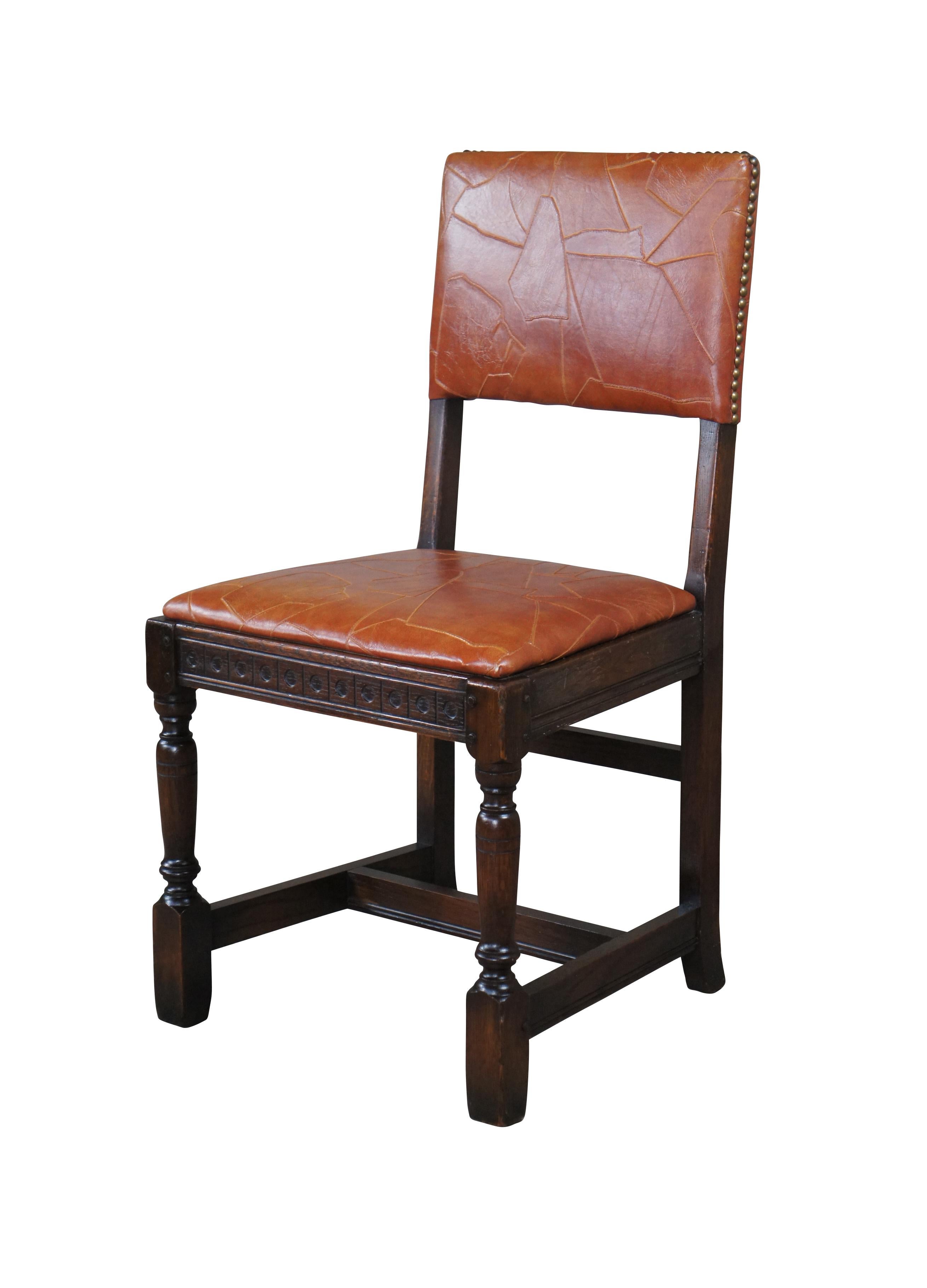 Spanish Revival dining side or desk chair by Saginaw Furniture, circa late 1930s to early 40s. Made from oak with turned legs connected by an H stretcher.  Upholstered in a modernist leather orange.

DIMENSIONS
18.5