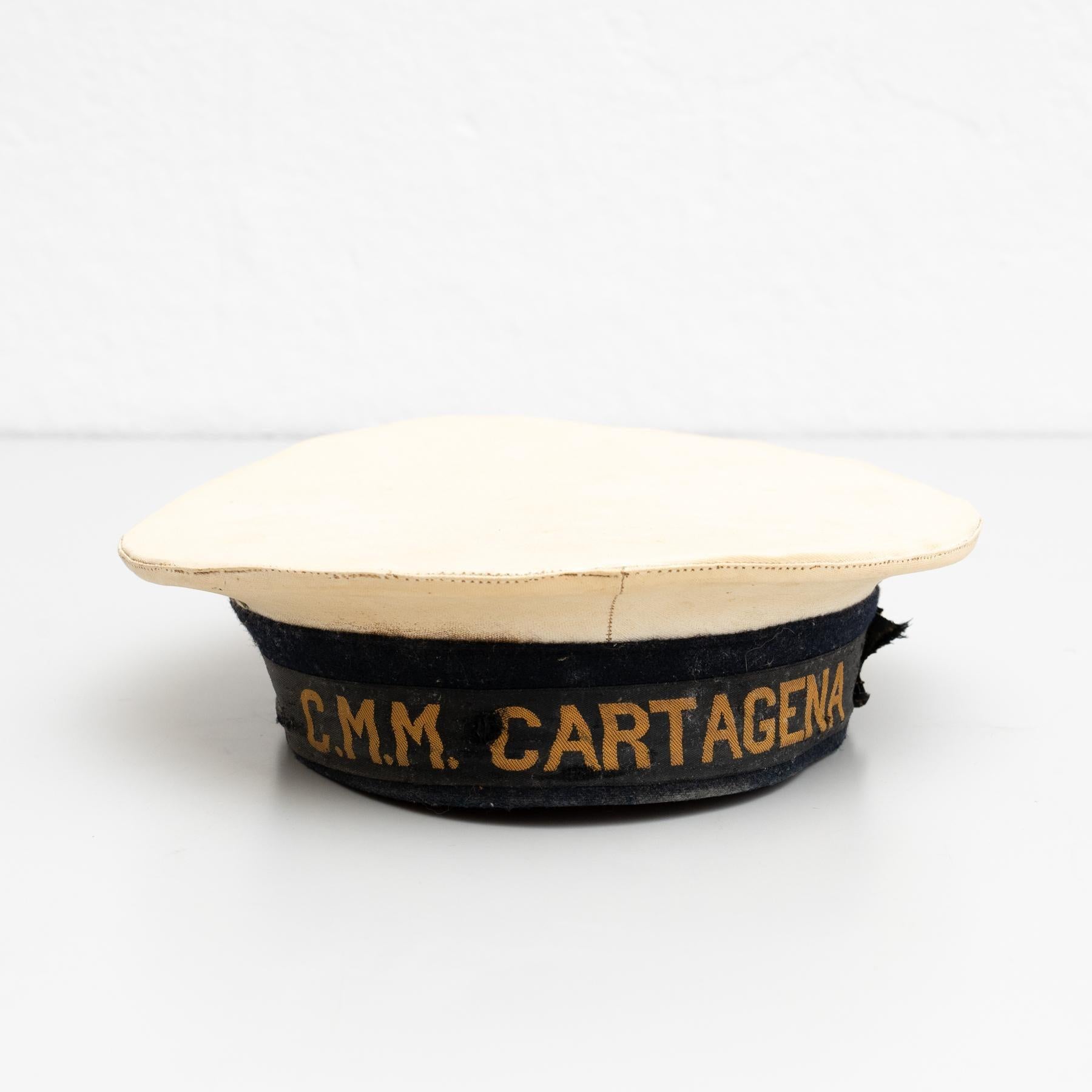 Fabric traditional sailor fabric hat.    Made by unknown manufacturer, circa 1950.    In original condition, with some visible signs of previous use and age, preserving a beautiful patina.    Materials:  Fabric.   