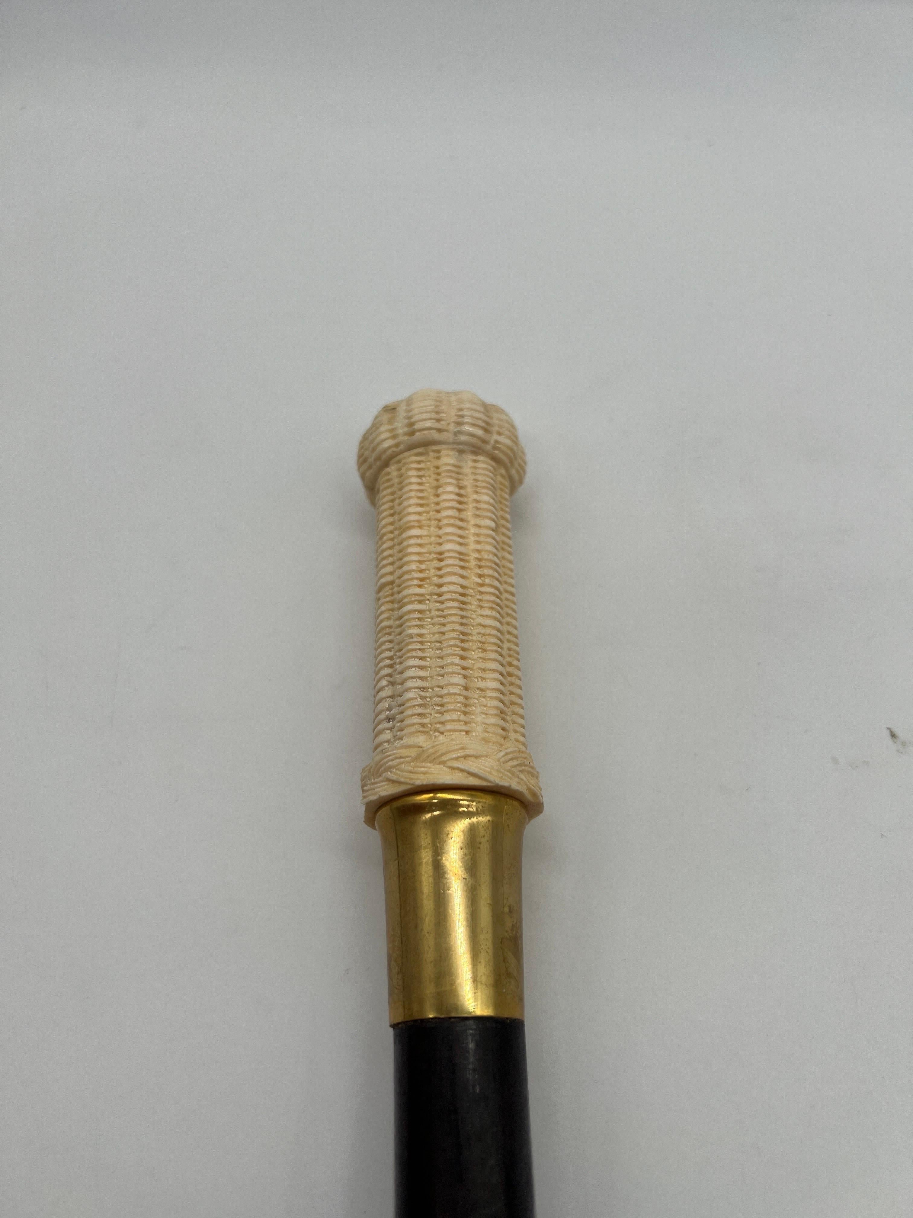 American, likely mid 20th century.

A carved bone walking stick in the form of a nantucket style basket which is mounted to an ebonized wood shaft and brass nub to base. Unmarked
Provenance: From a private Newport collection. 