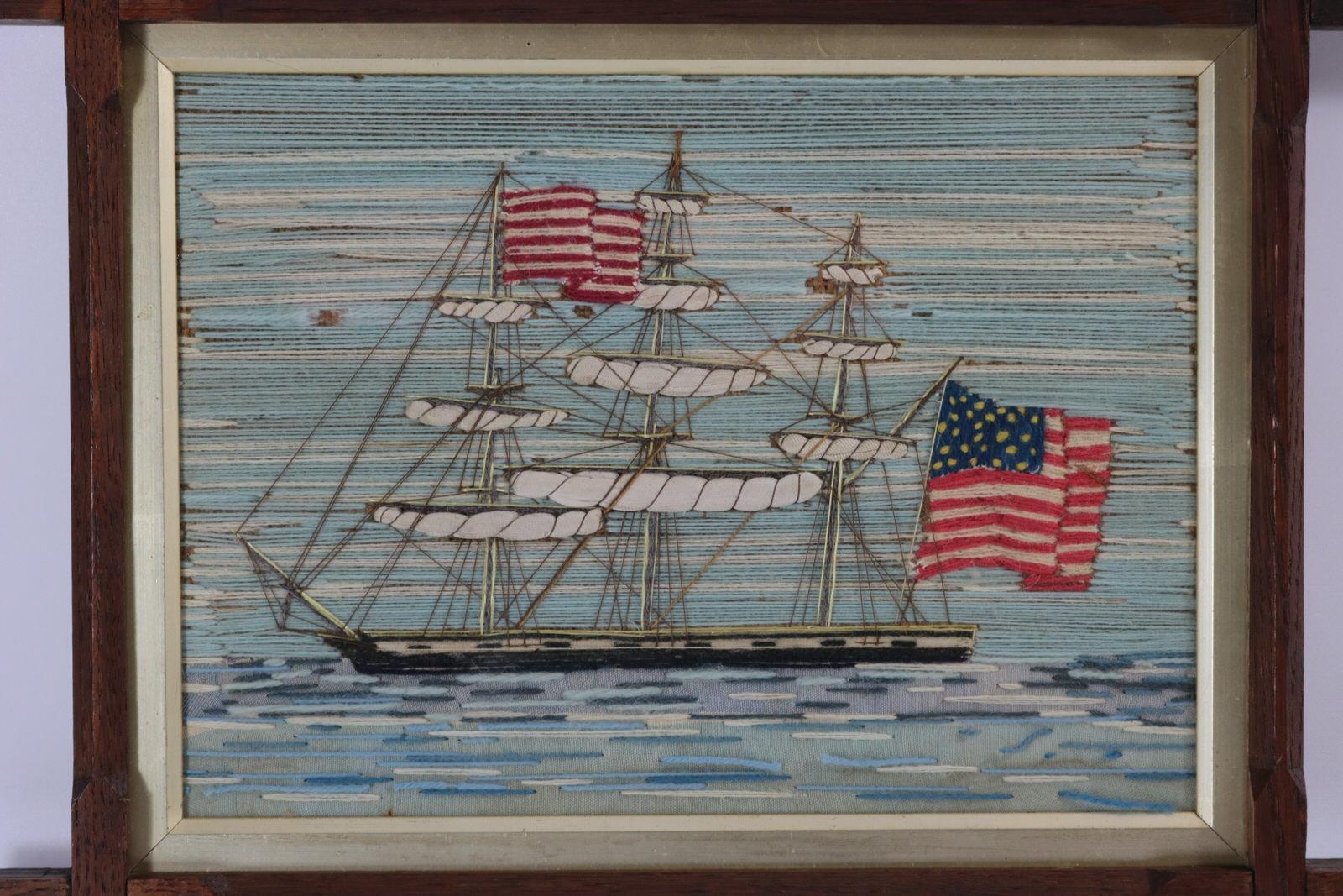 Antique Sailor's Woolwork Embroidery Picture of an American three masted ship. The embroidery is worked in wool on canvas ground, in a variety of stitches with raised work flags and sails of silk-like material. Colours white, cream, blues, black,