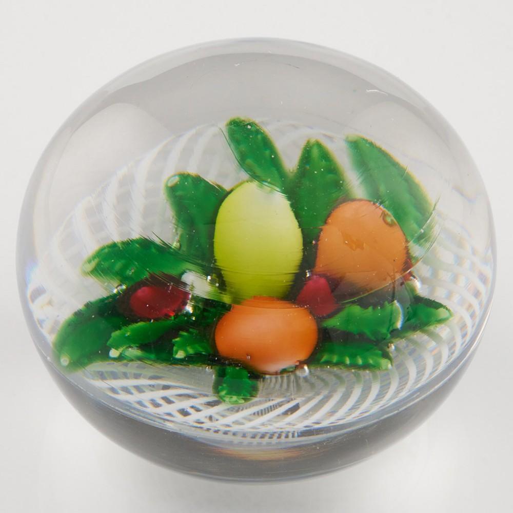 Heading : Antique Saint Louis Fruit Bouquet Paperweight c1850
Date : c1850
Origin : France
Features :  Orange, lemon, pear and cherries  on a bed of green leaves on a latticinio bouquet 

Marks : None
Type : Lead
Size : 8.0cm diameter
Condition :