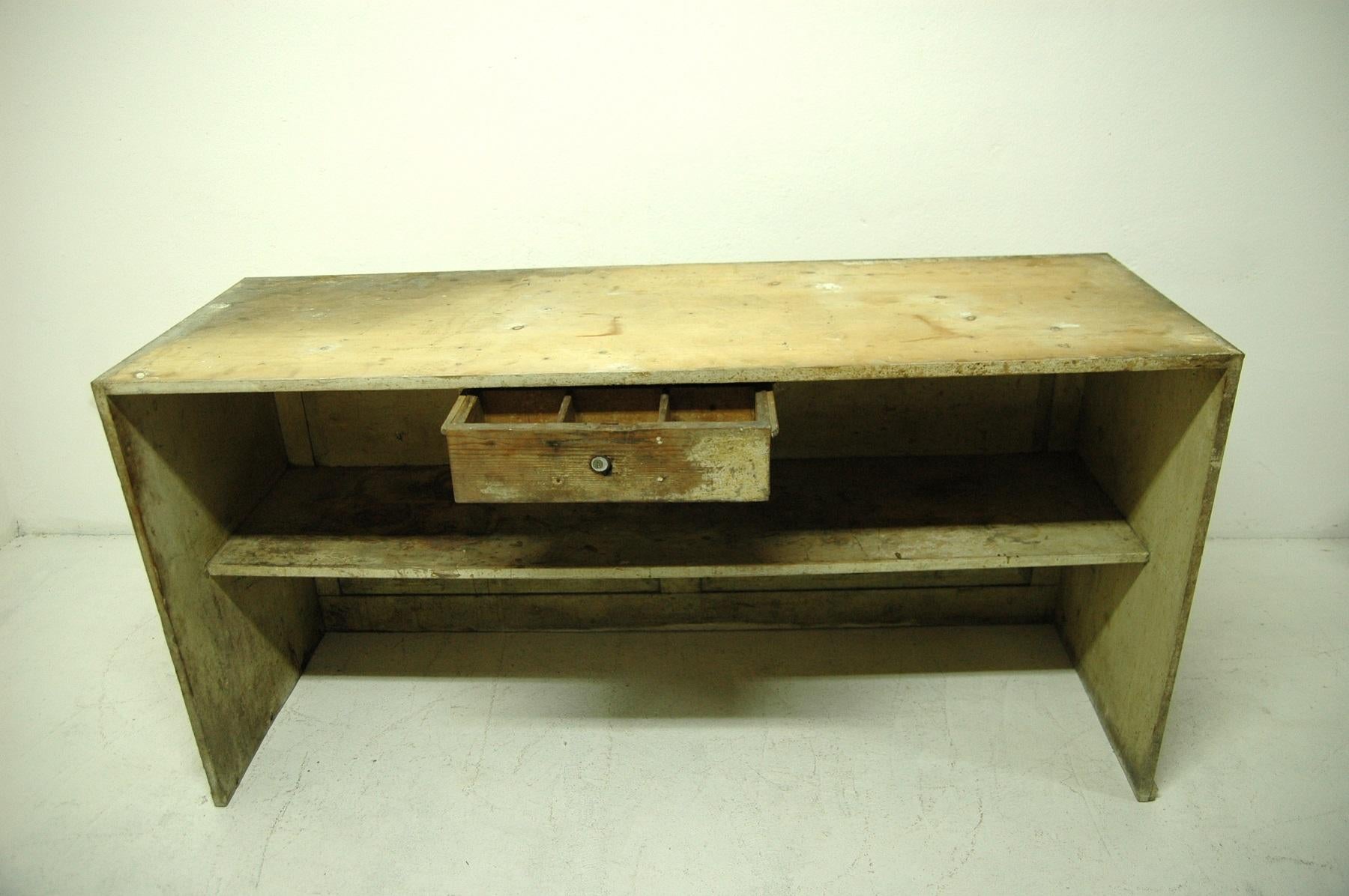 Antique sales counter from the 1920s. This table was made of spruce or pine wood. It was used as a sales counter in a grocery store in Bohemia. Structurally very well preserved, the surface bears a natural patina due to age and use.

Measures: