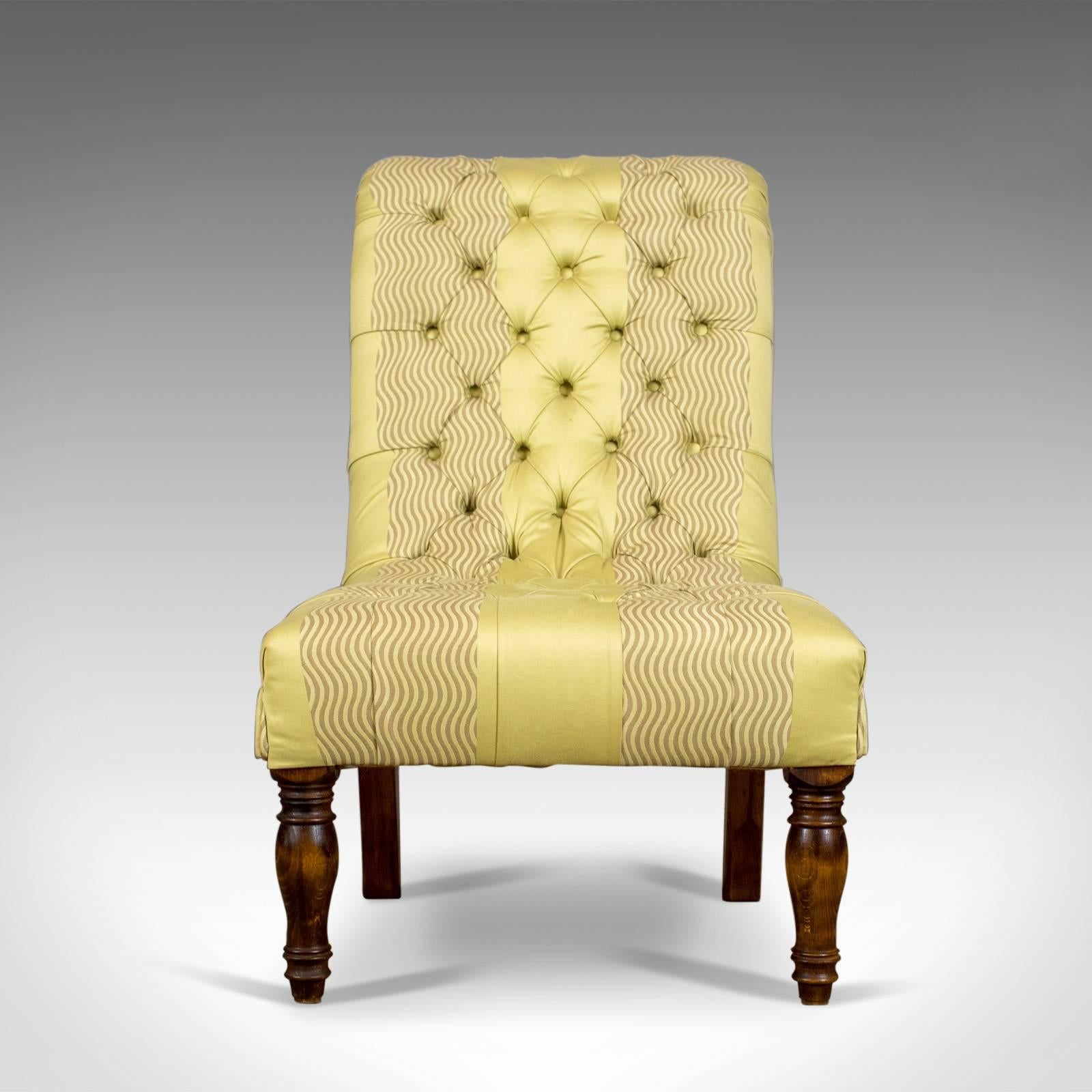 This is an antique salon chair, an English button back bedroom chair dating to the Victorian era, circa 1870.

Attractive sinuous form featuring a rolled, scrolled top
Professionally upholstered in a subtle silk cotton cloth
Traditionally
