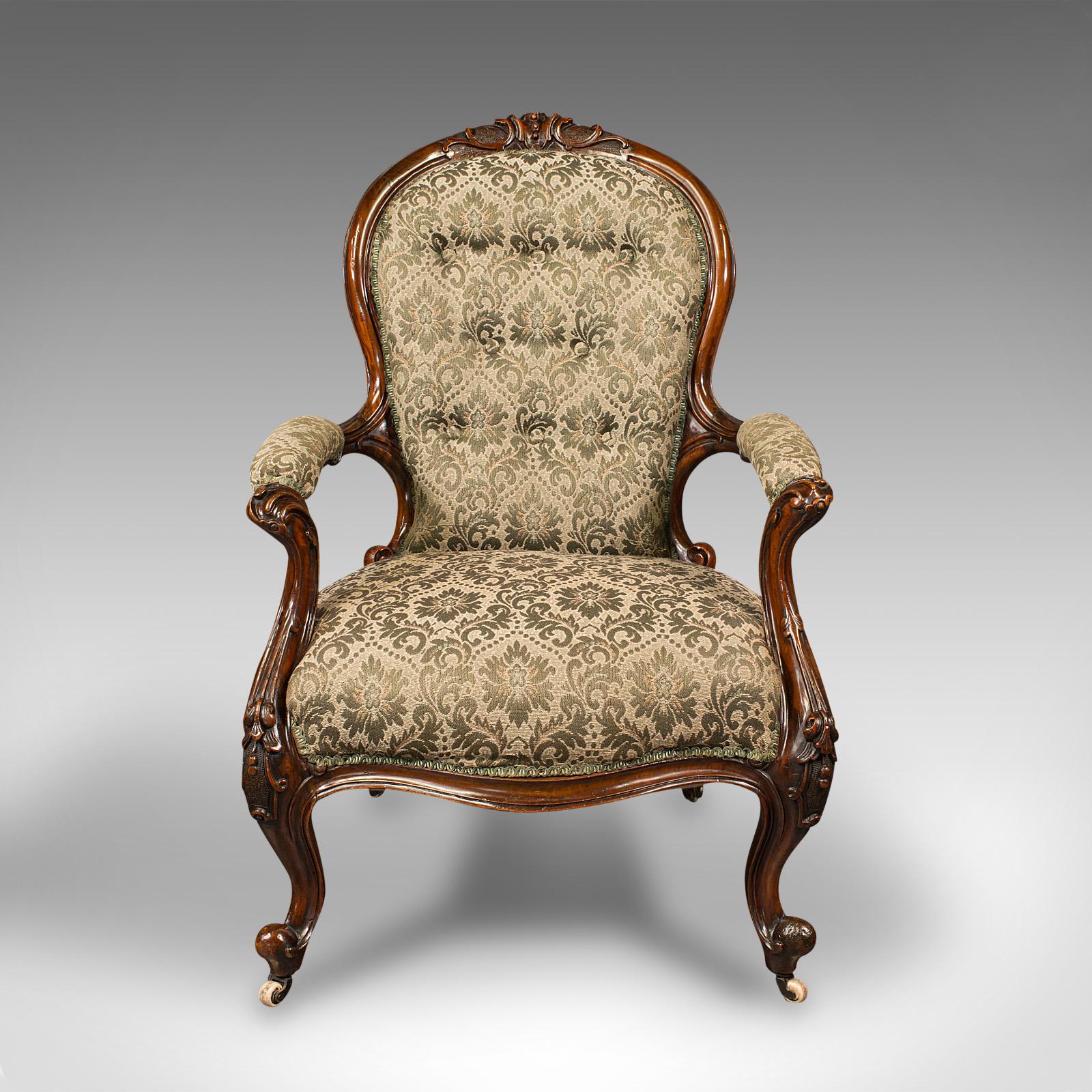 This is an antique salon chair. An English, walnut armchair, dating to the early Victorian period, circa 1840.

Beautifully appointed salon chair with relaxing, lounge or fireside appeal
Displays a desirable aged patina and in good order
Select