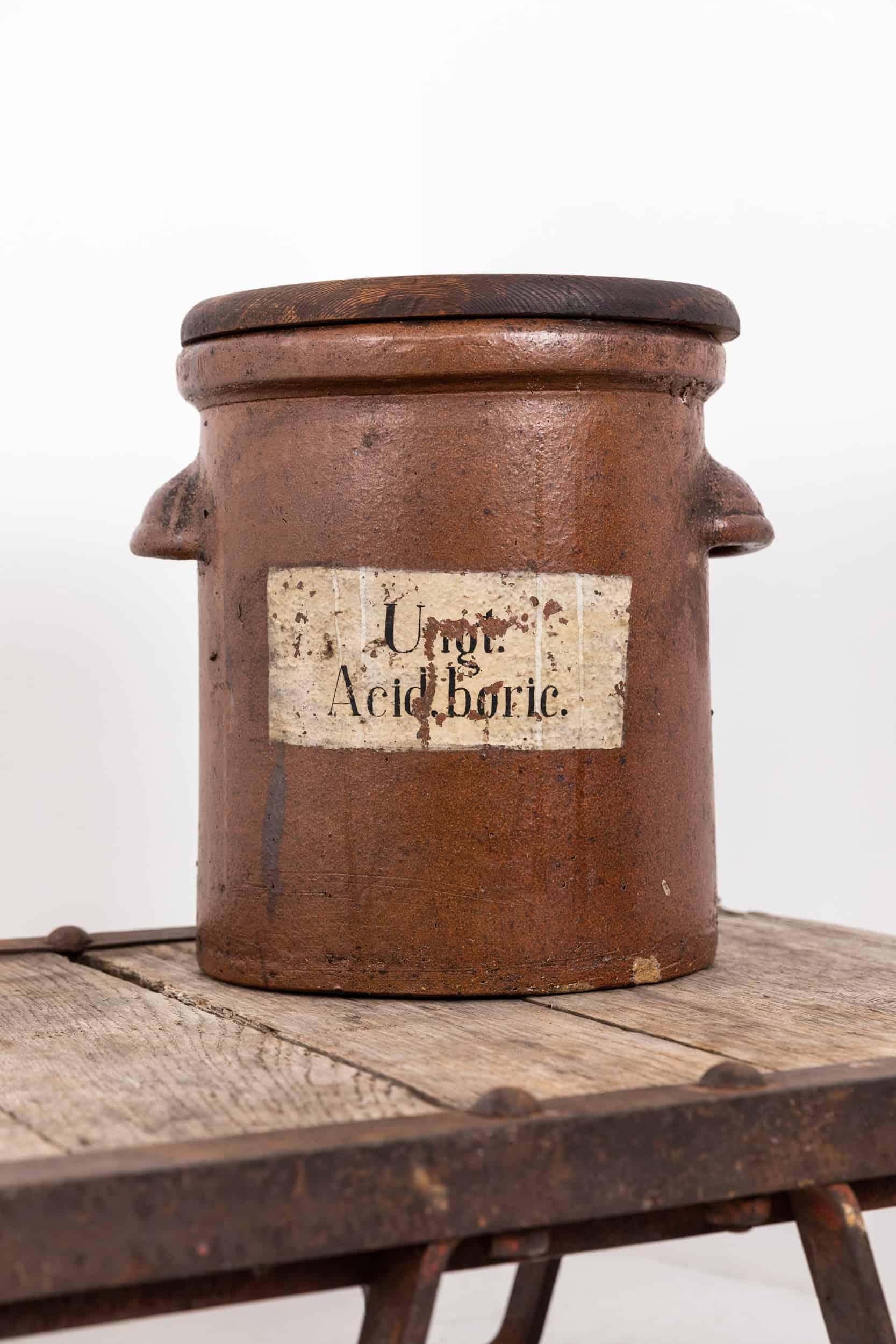 An original salt glazed clay apothecary jar. c.1900

Once containing boric acid and likely used is a pharmacy. Perfect for repurposing as a plant pot or log bin. Remnants of the hand painted label remain, with integral cupped handles either side and