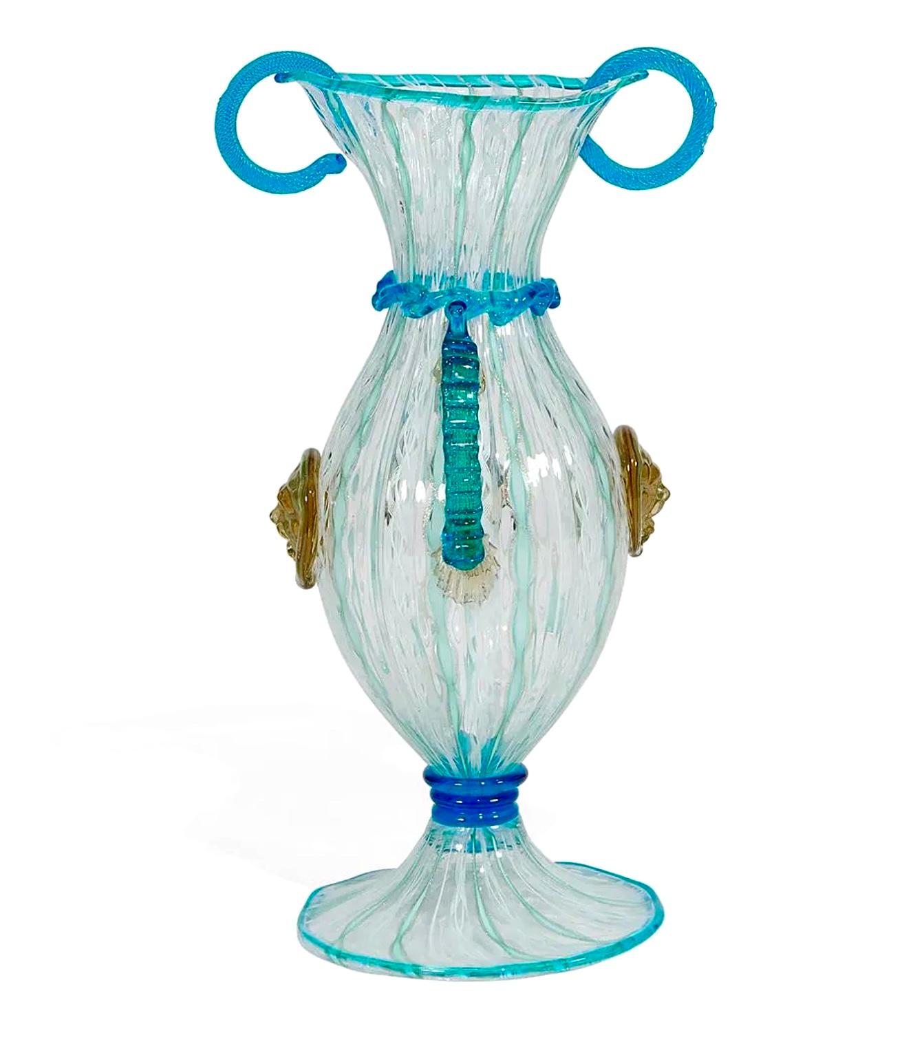 Antique Dr. Antonio Salviati Venetian Serpentine double-handled vase with lions, Italy, 1870s. Gorgeous double-handled serpentine design with vibrant hues of blue, ruffled appliqué trim and lion head emblems in sublime gold beige. 24 k gold