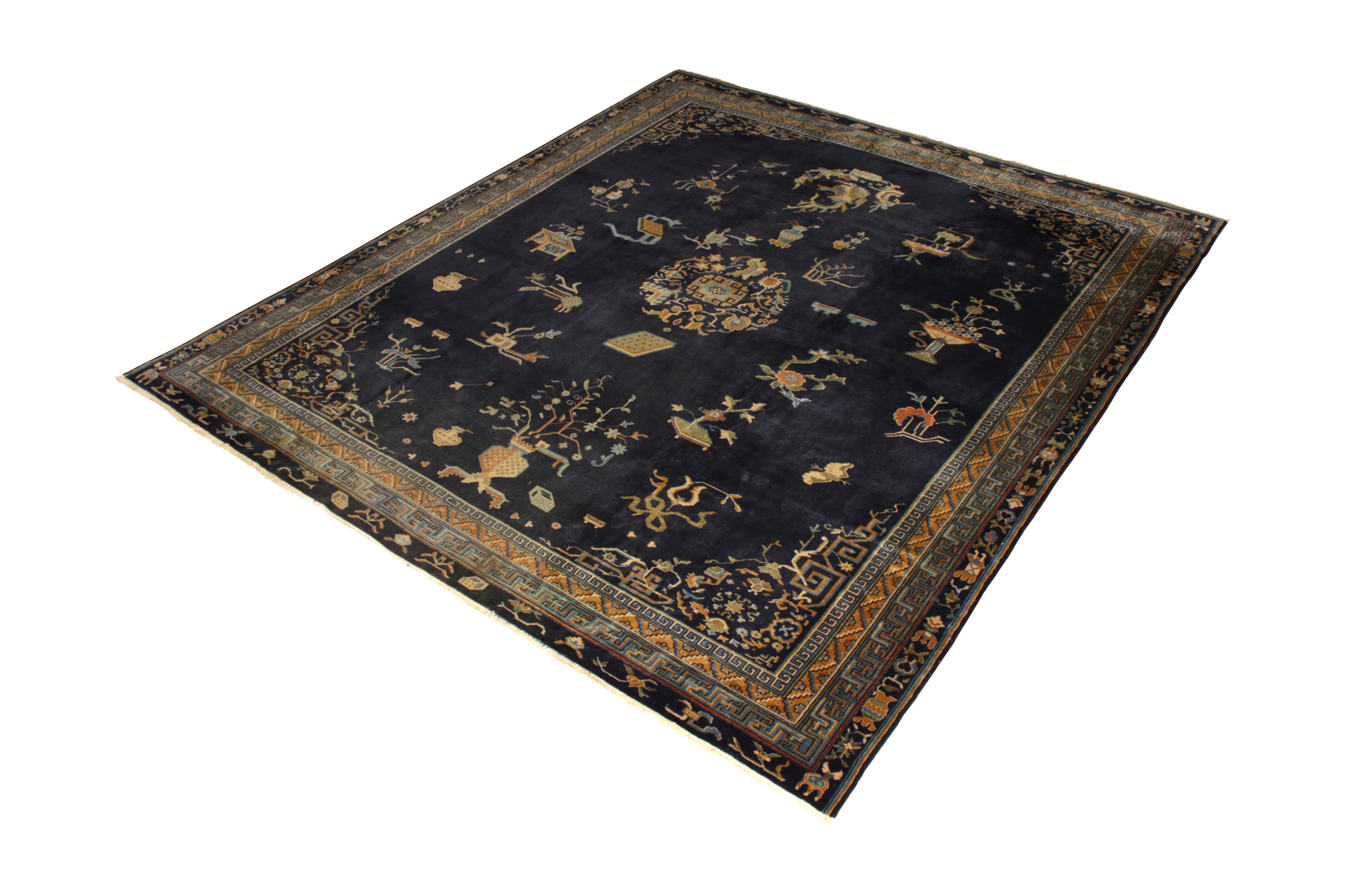 Hand knotted in wool originating from India circa 1920, this antique art deco rug connotes a Samarkand rug design, inspired by neighboring Peking rugs with a unique colloquial take. A regal play of navy blue and gold hues both inspires a classic