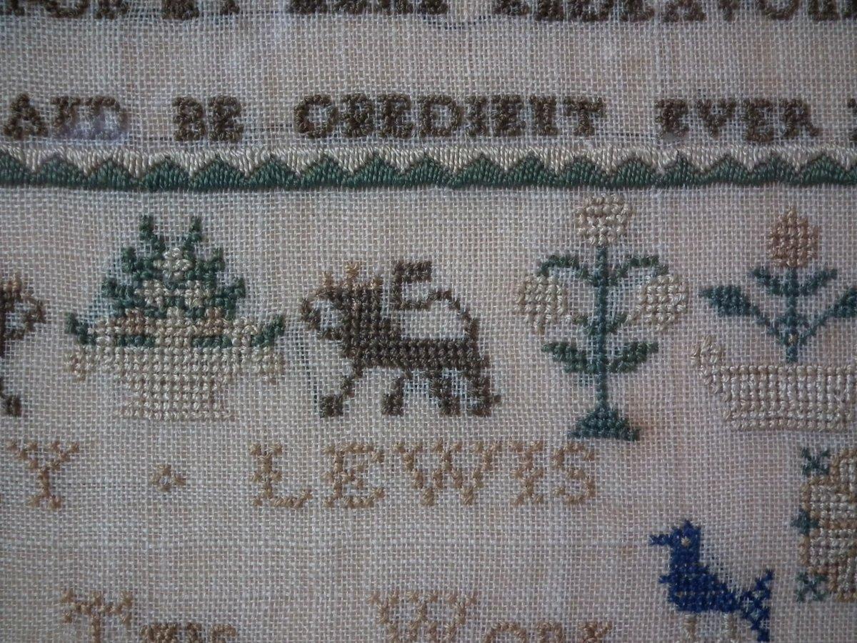 1832 Verse Sampler by Mary Lewis. The sampler is worked in silk on linen ground, in cross stitch throughout. Meandering strawberry border. Colors green, cream, navy blue, pale blue, light brown and yellow. Alphabets A-Z in upper case and numbers