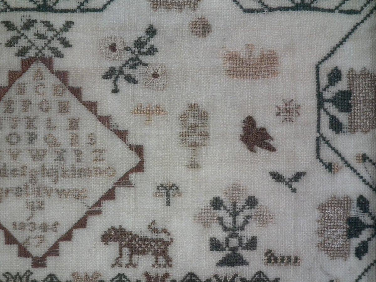 1832 sampler by Sarah Pountain. The sampler is worked in silk on linen ground, in a variety of stitches. Meandering floral border. Colors green, cream, copper, gold, brown and blue. Alphabets A-Z in upper case and lower case and numbers 1-7 Verse